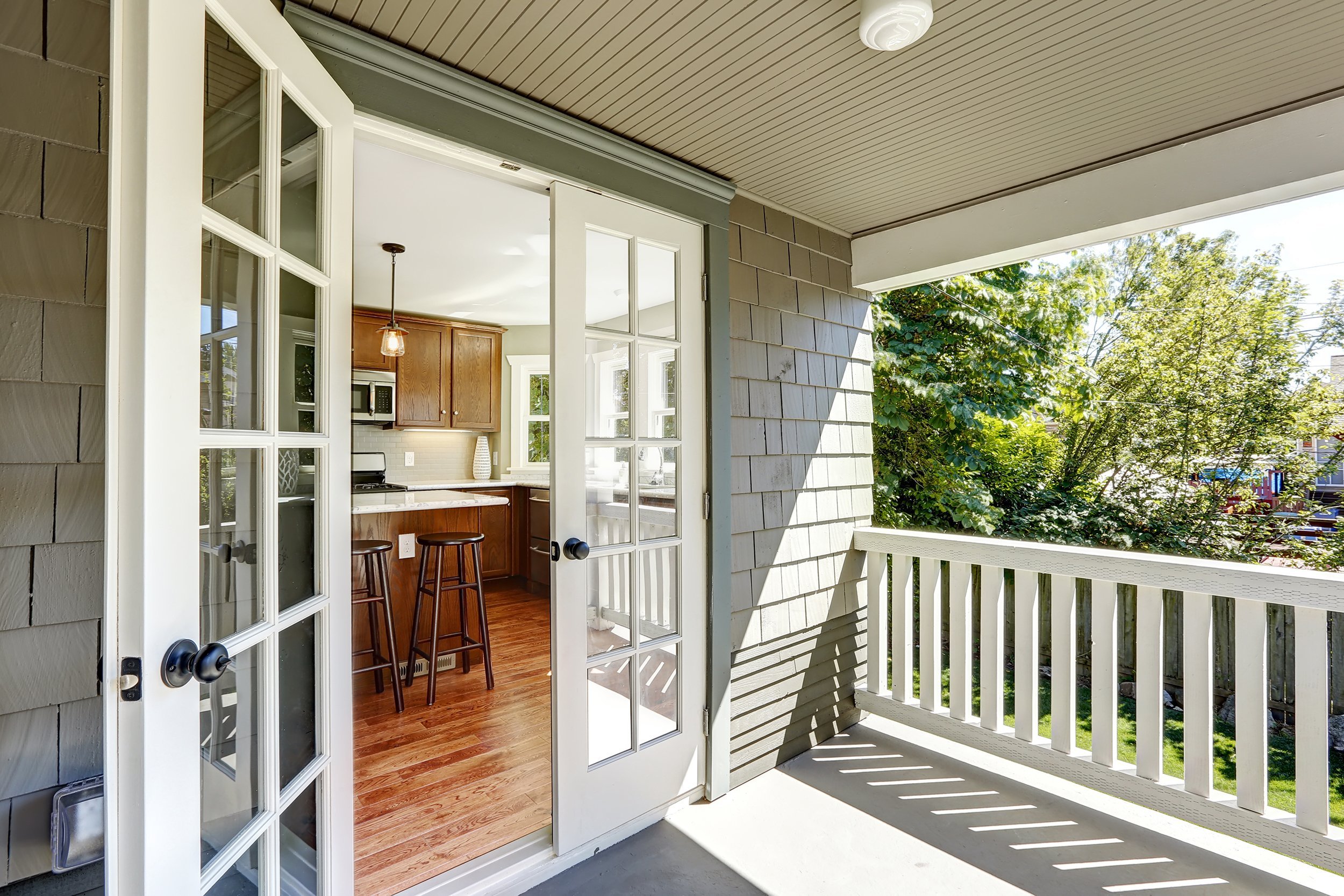 French doors open kitchen room to backyard