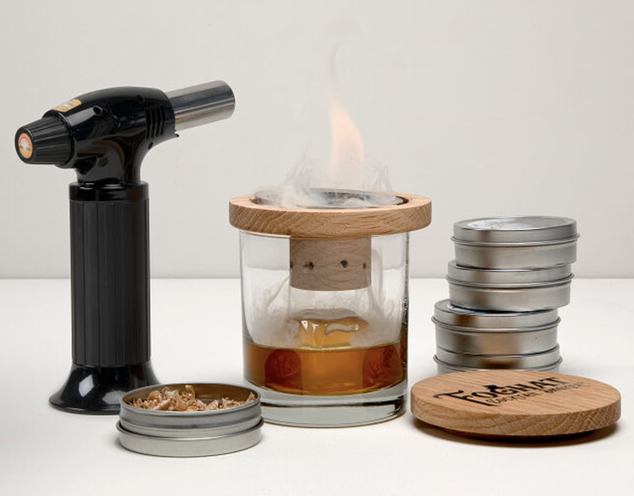 Glass Topper Cocktail Smoker- showing the smoker being used with a glass on fire on the top liquid