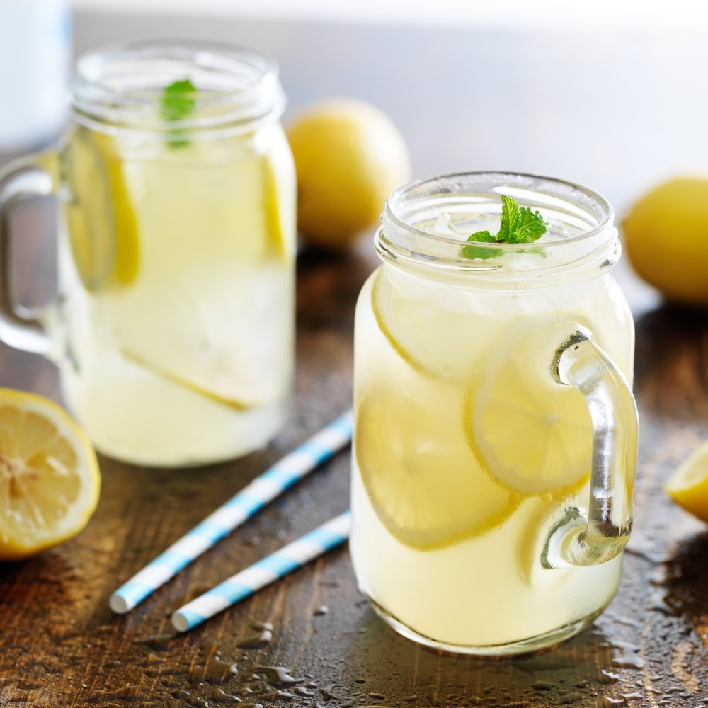 bell jars of fresh squeezed lemonade garnished with mint