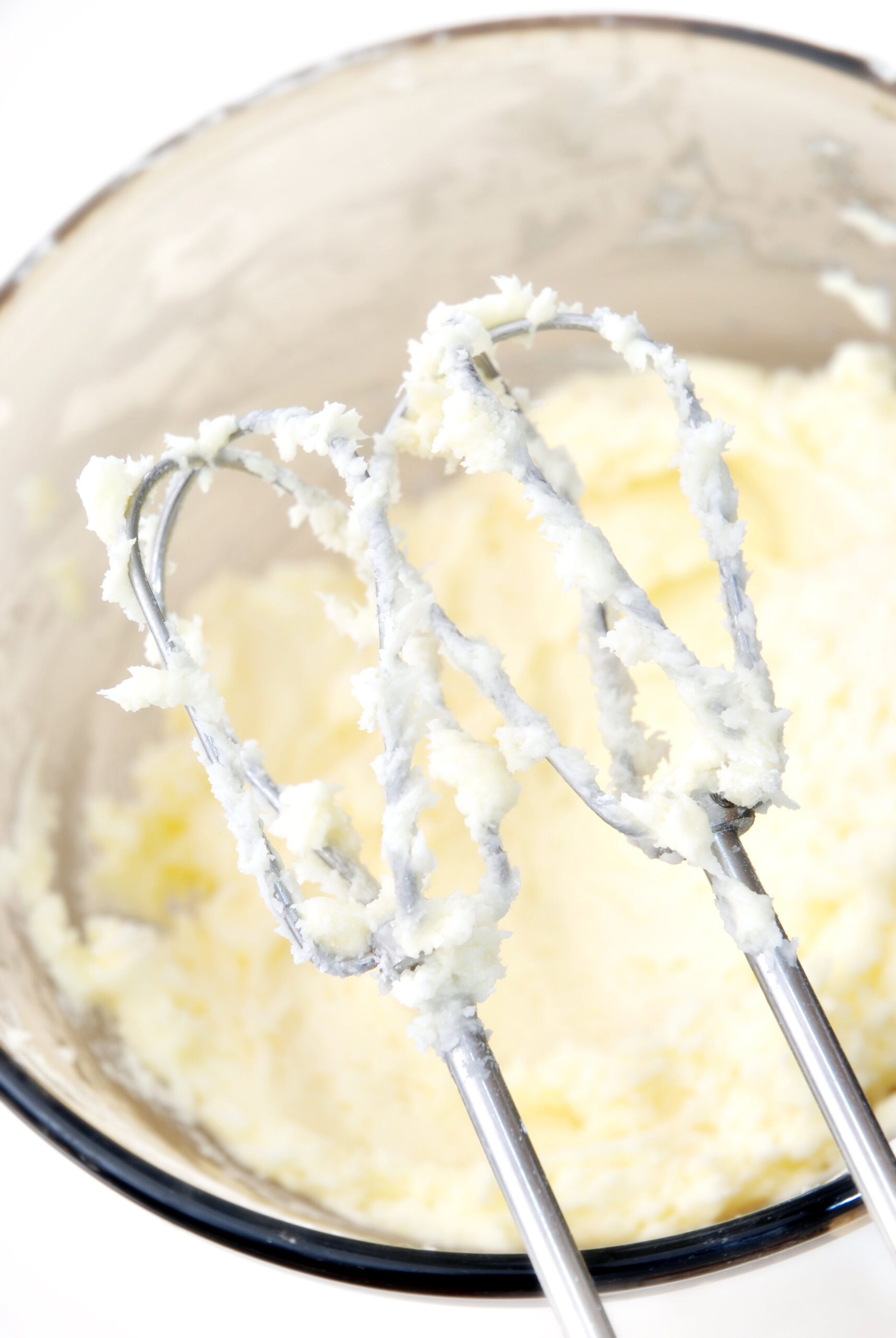 mixing beaters covered with buttercream frosting