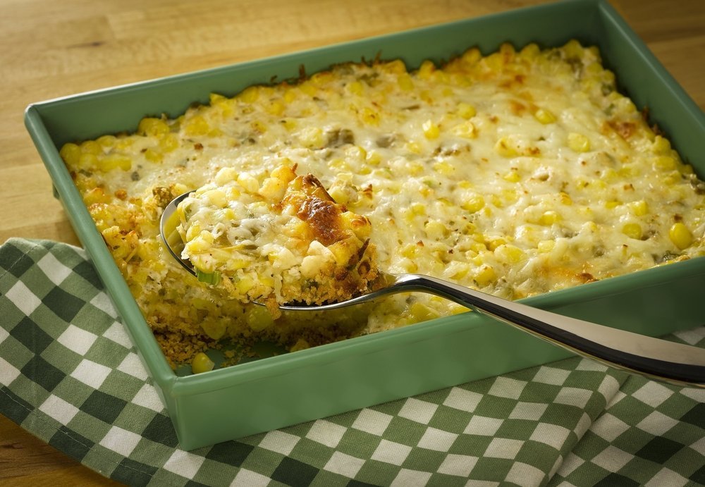 serving spoon scooping out a helping of corn casserole