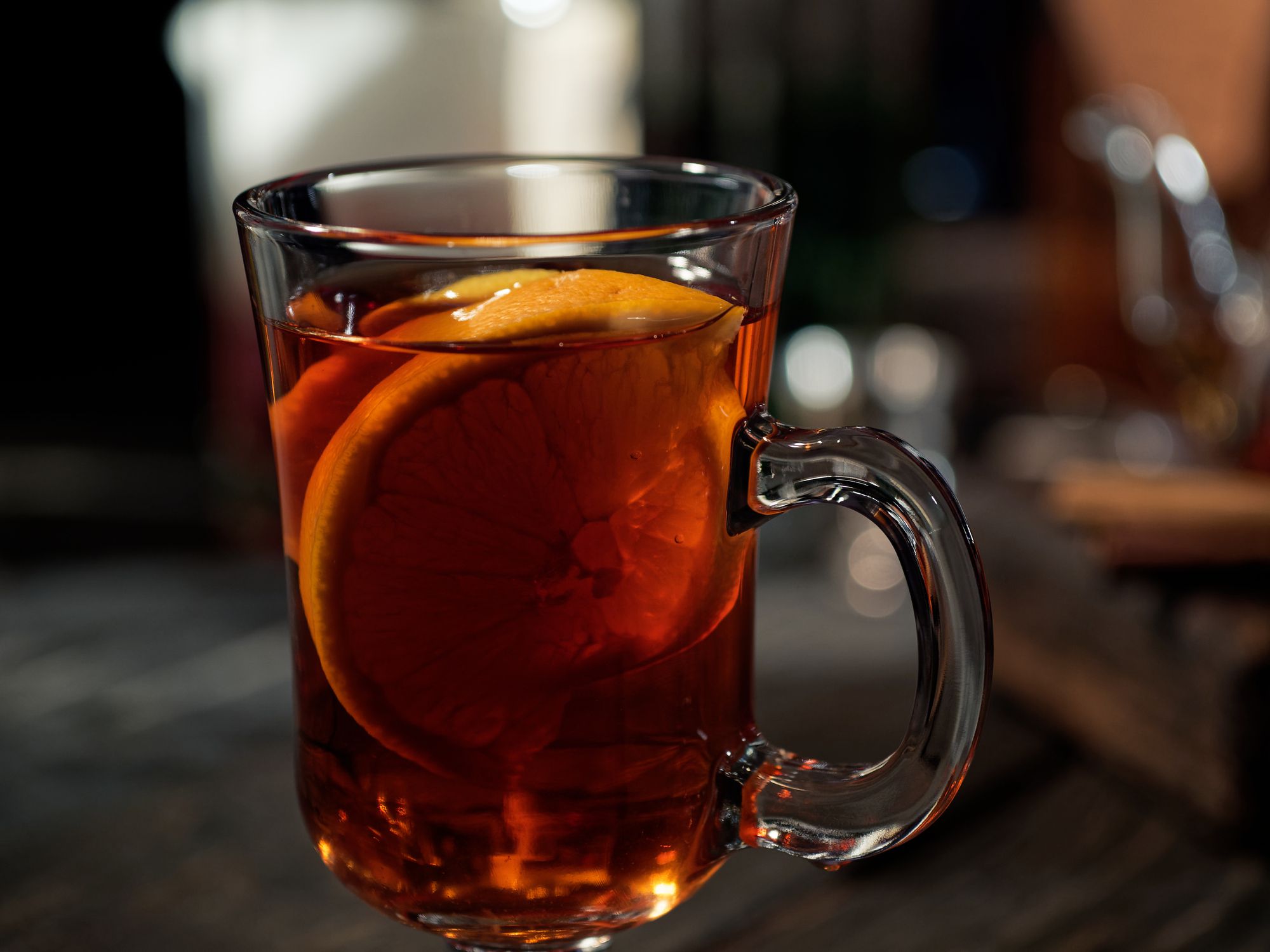 Preparing spiced grog with tea and fruit on the bar counter