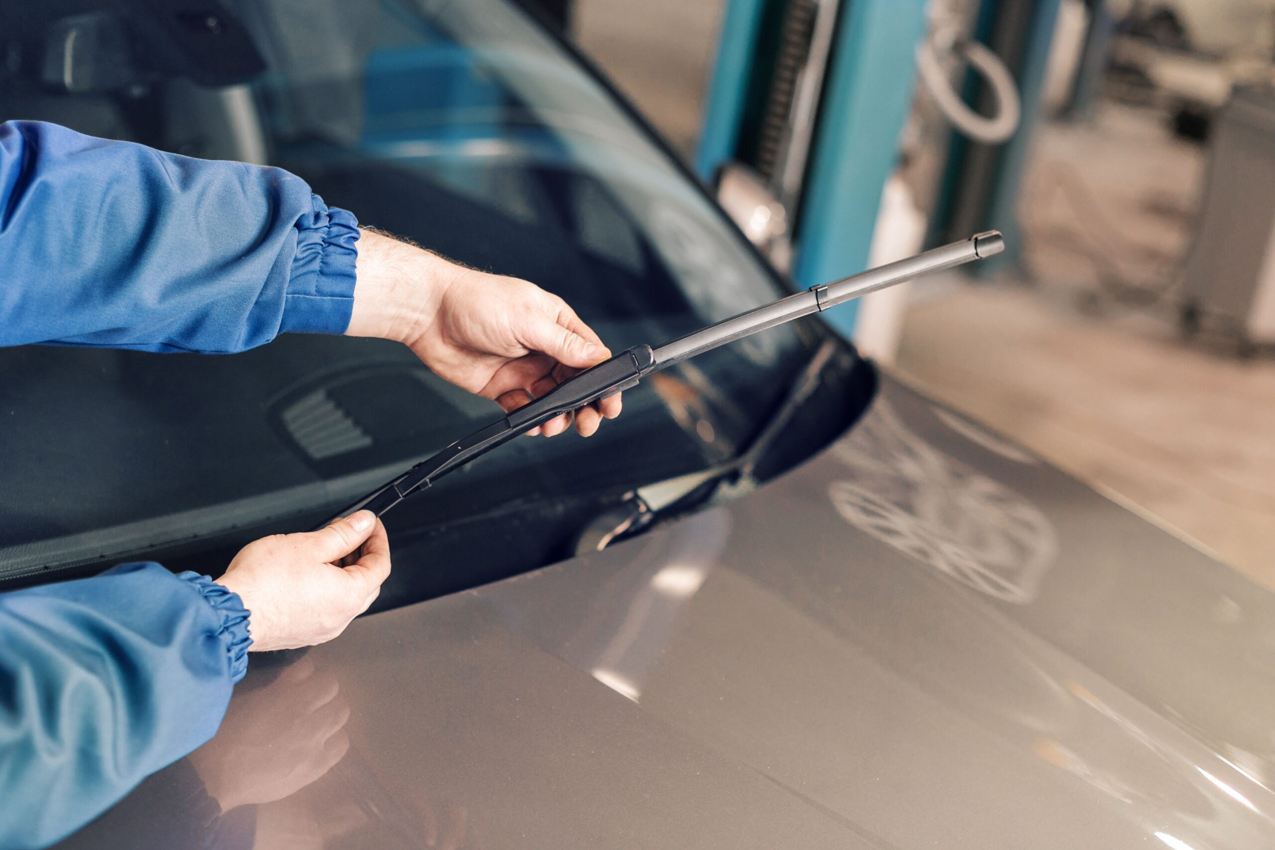hands changing windshield wipers