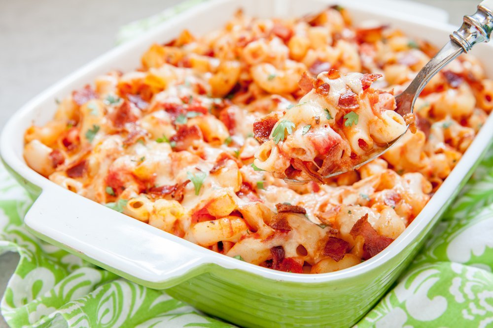 Pasta casserole with bacon, ham, cheese and tomato sauce