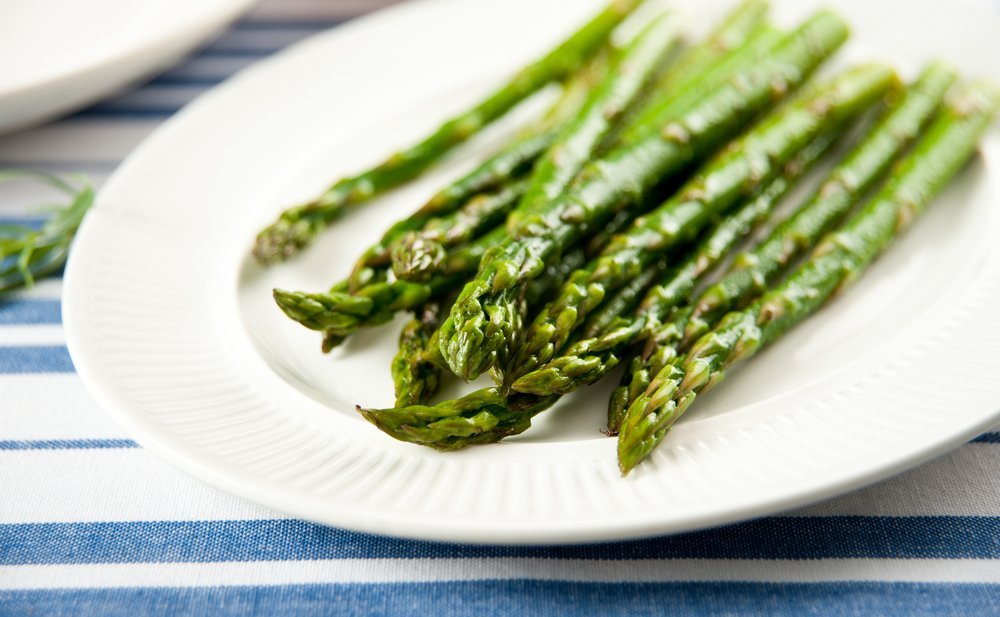 white plate with sauteed asparagus
