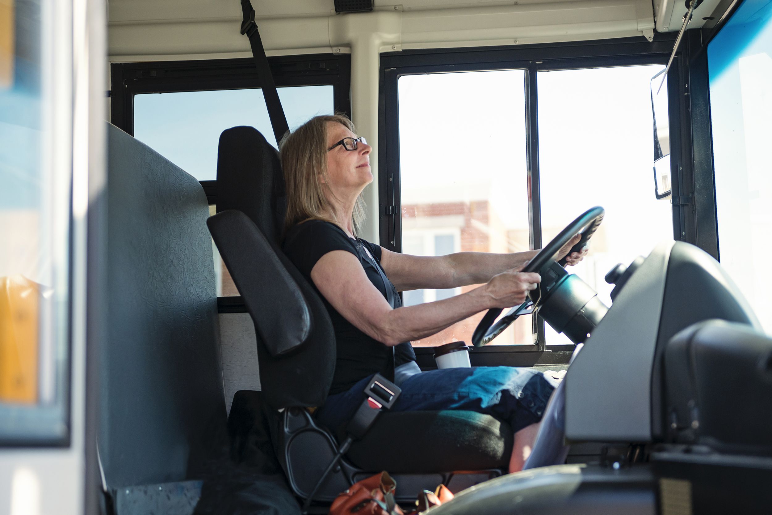 mature woman driving a school bus