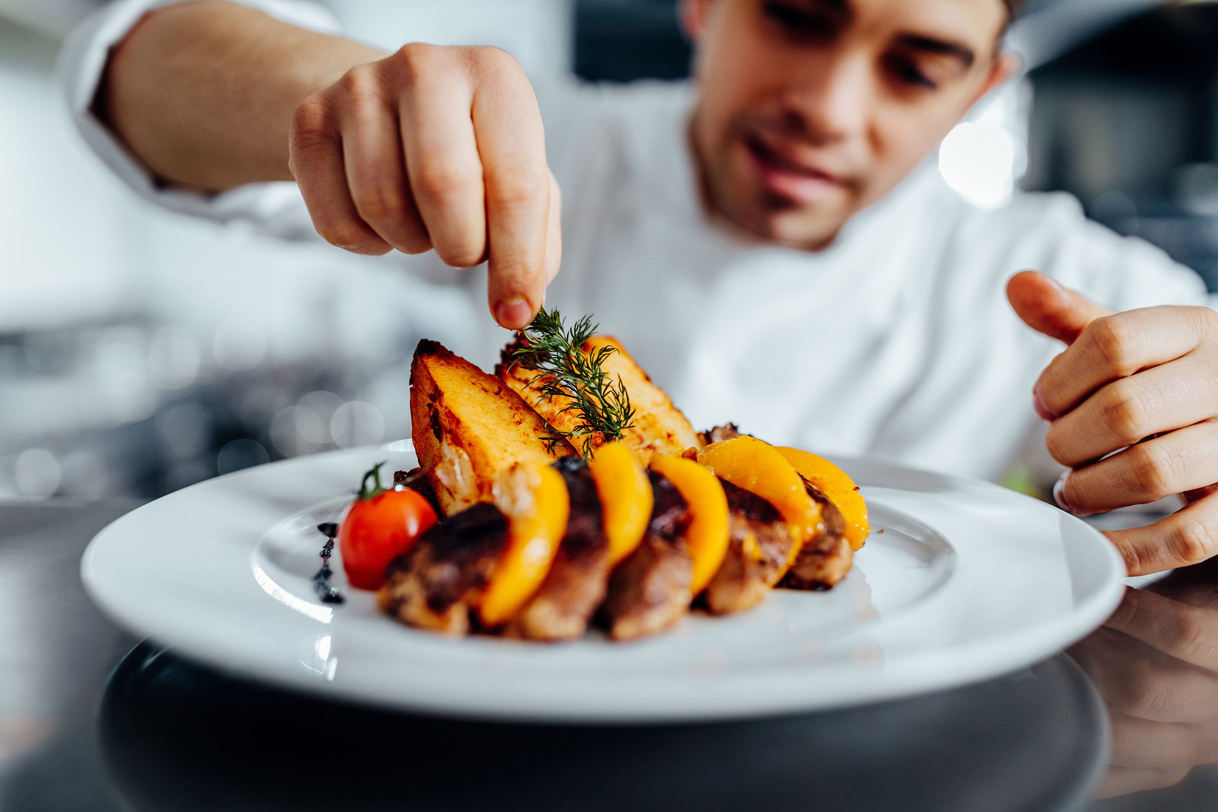 professional chef garnishing food