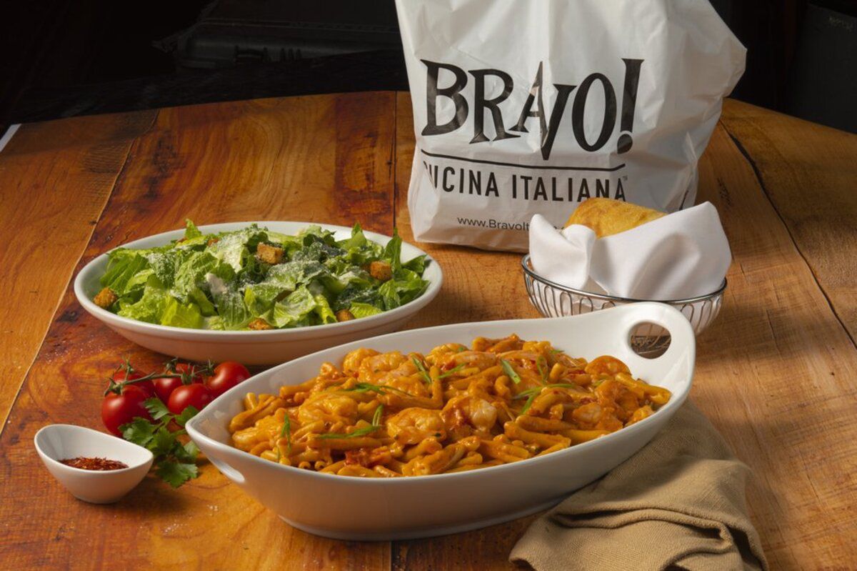 bowl of pasta, bowl of salad and bag of Bravo! Cucina Italiana, Kansas City, Missouri