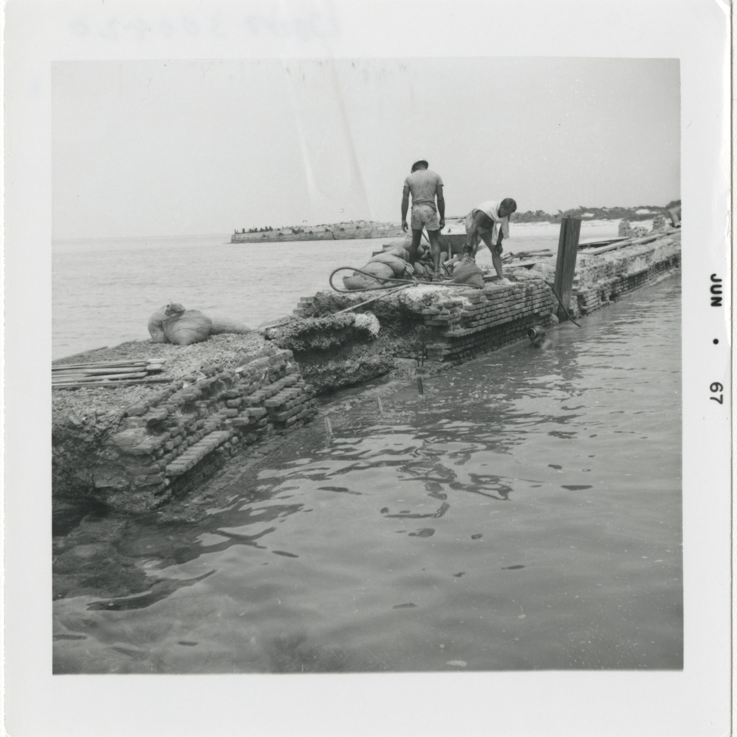 Men repairing seawall, Fort Jefferson, June 1967