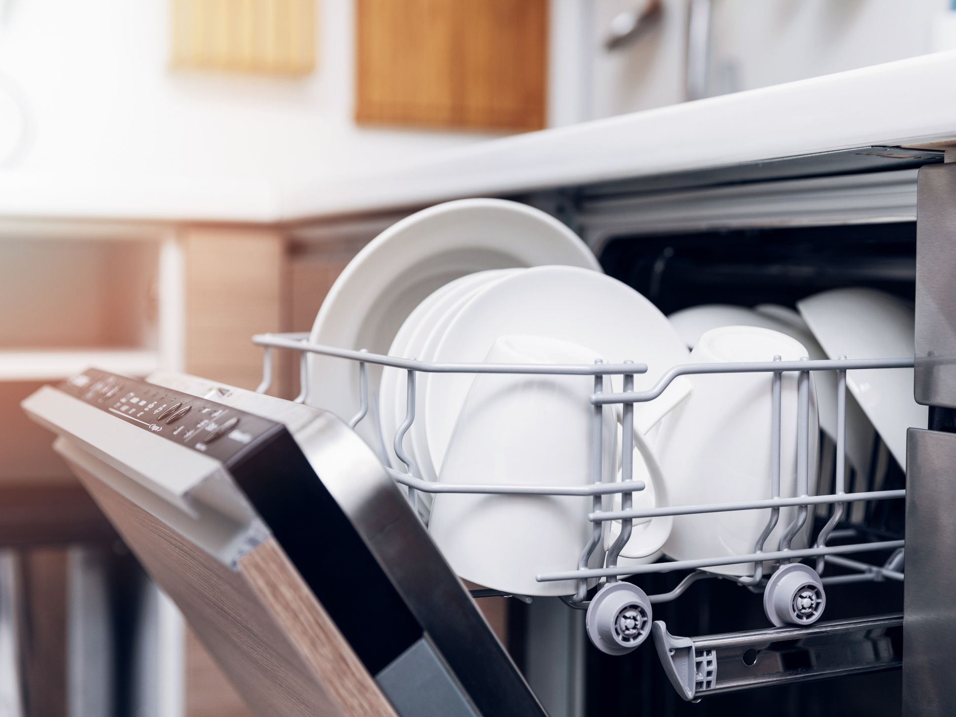 open dishwasher with clean dishes at home kitchen