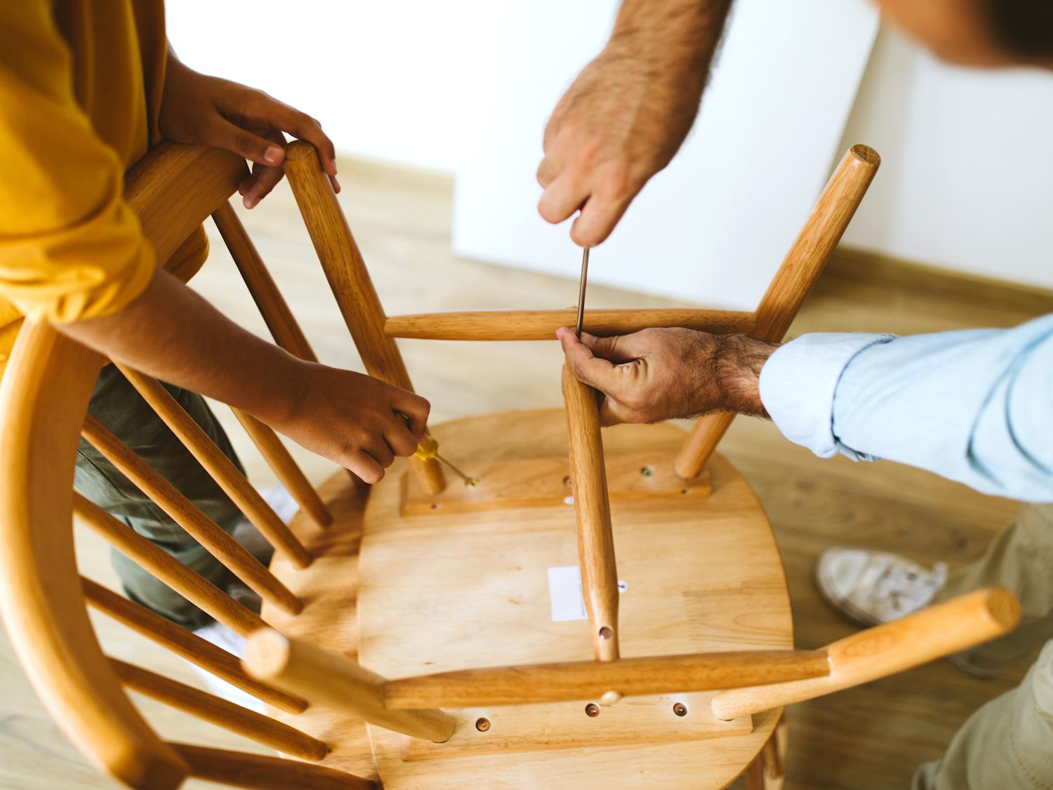 Father and son assembling chair