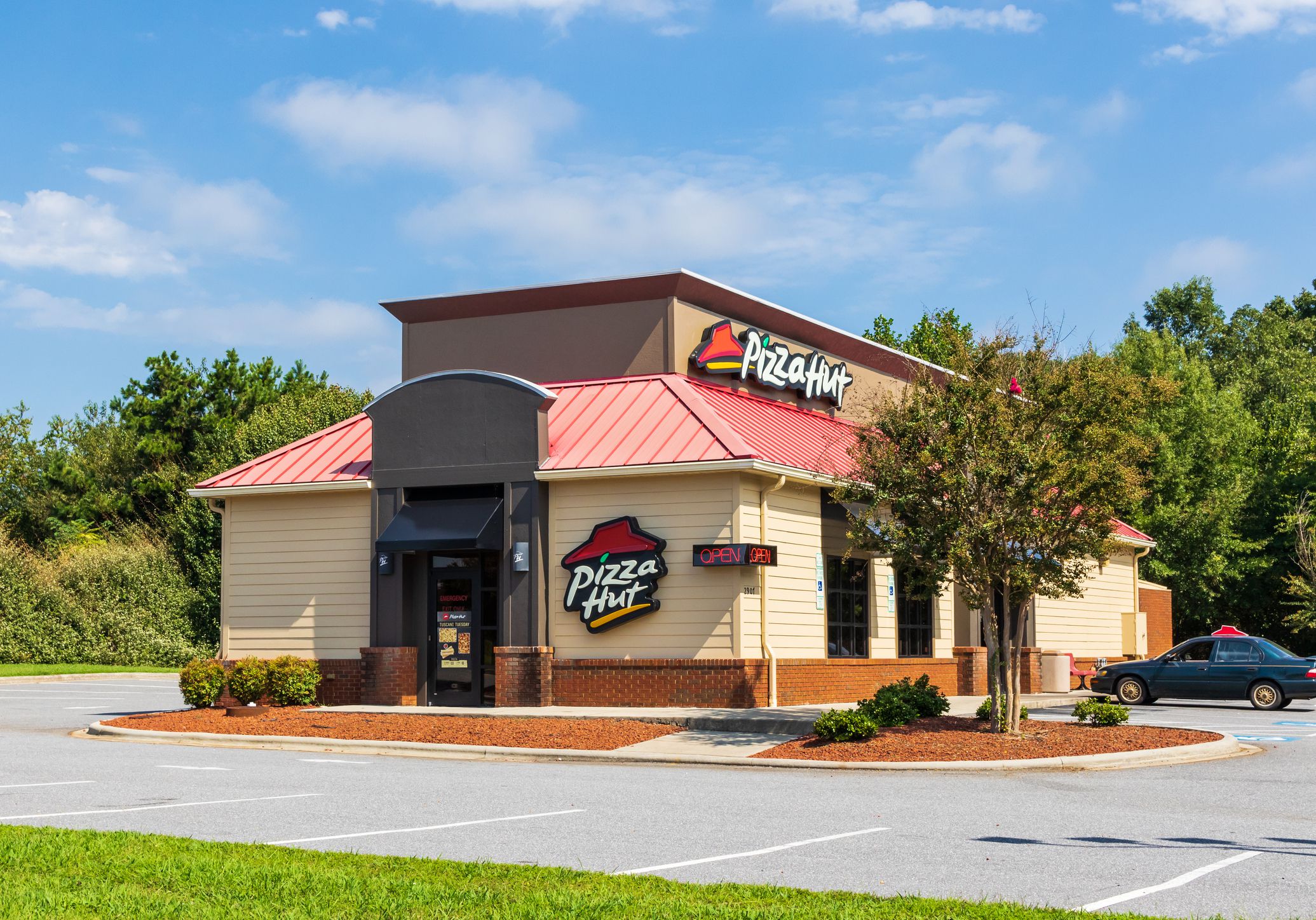 front of Pizza Hut, Hickory, North Carolina with car parked in the parking lot on a clear sunny day