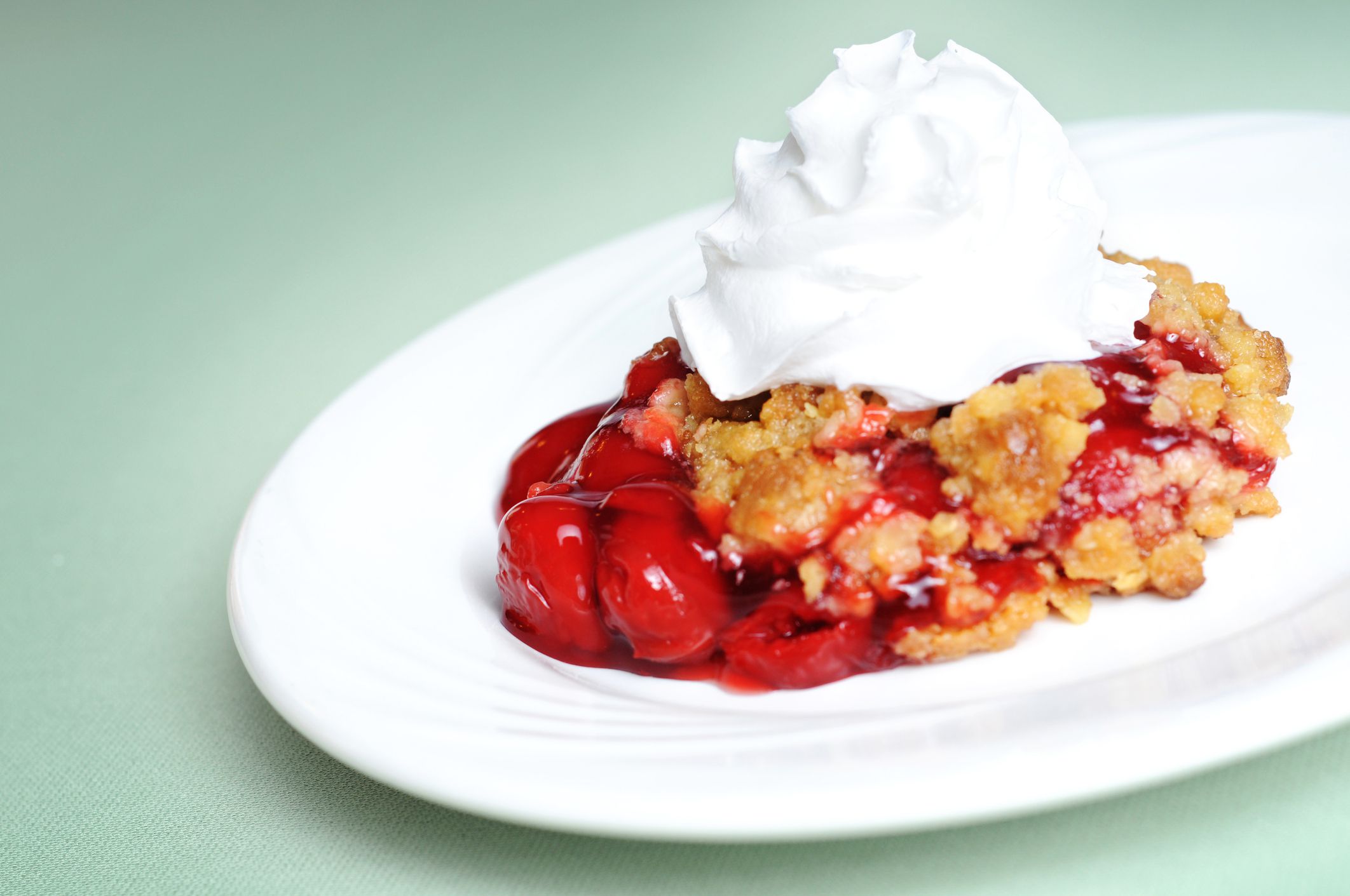 Delicious cherry cobbler topped with whipped cream.