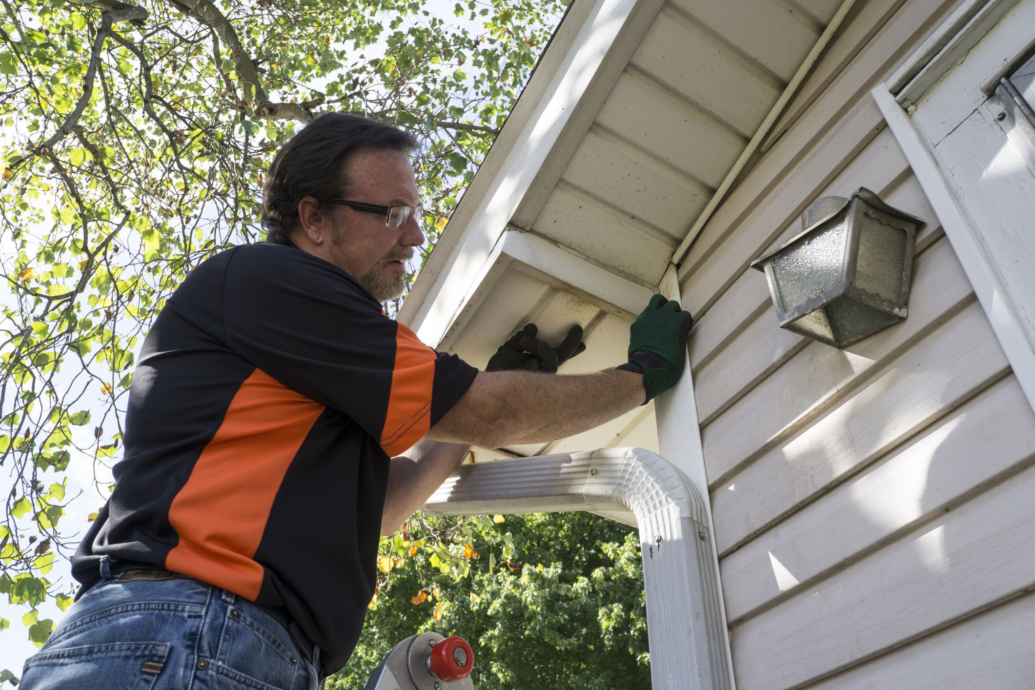 Contractor popping vinyl siding back in place for a customer.