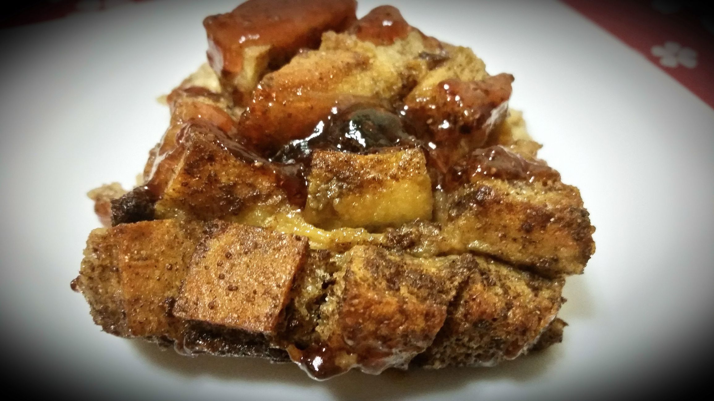 Bread Pudding with Strawberry jam and raisins on a plate