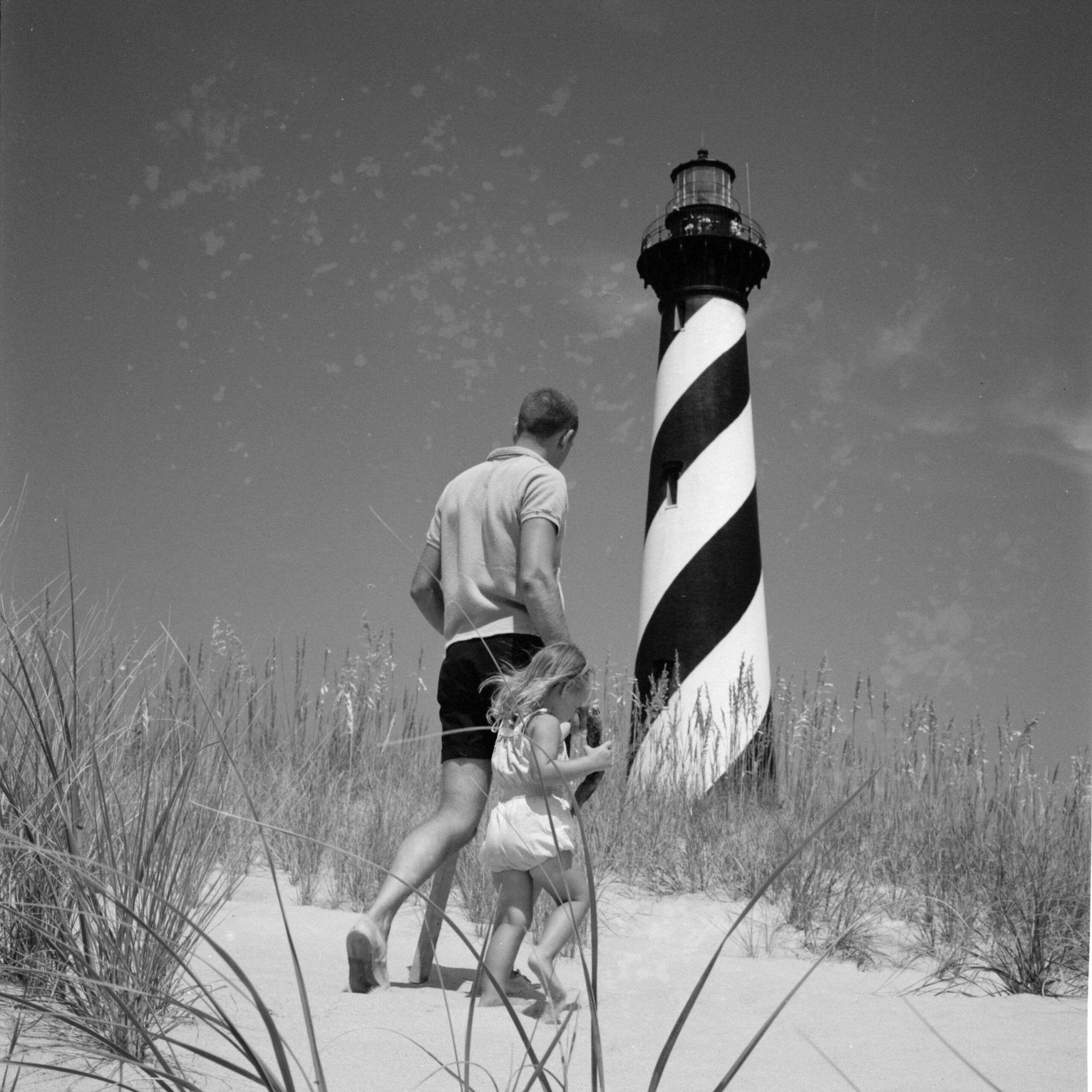 Visitors walk among sea oats and sand dunes, Cape Hatteras National Seashore, North Carolina