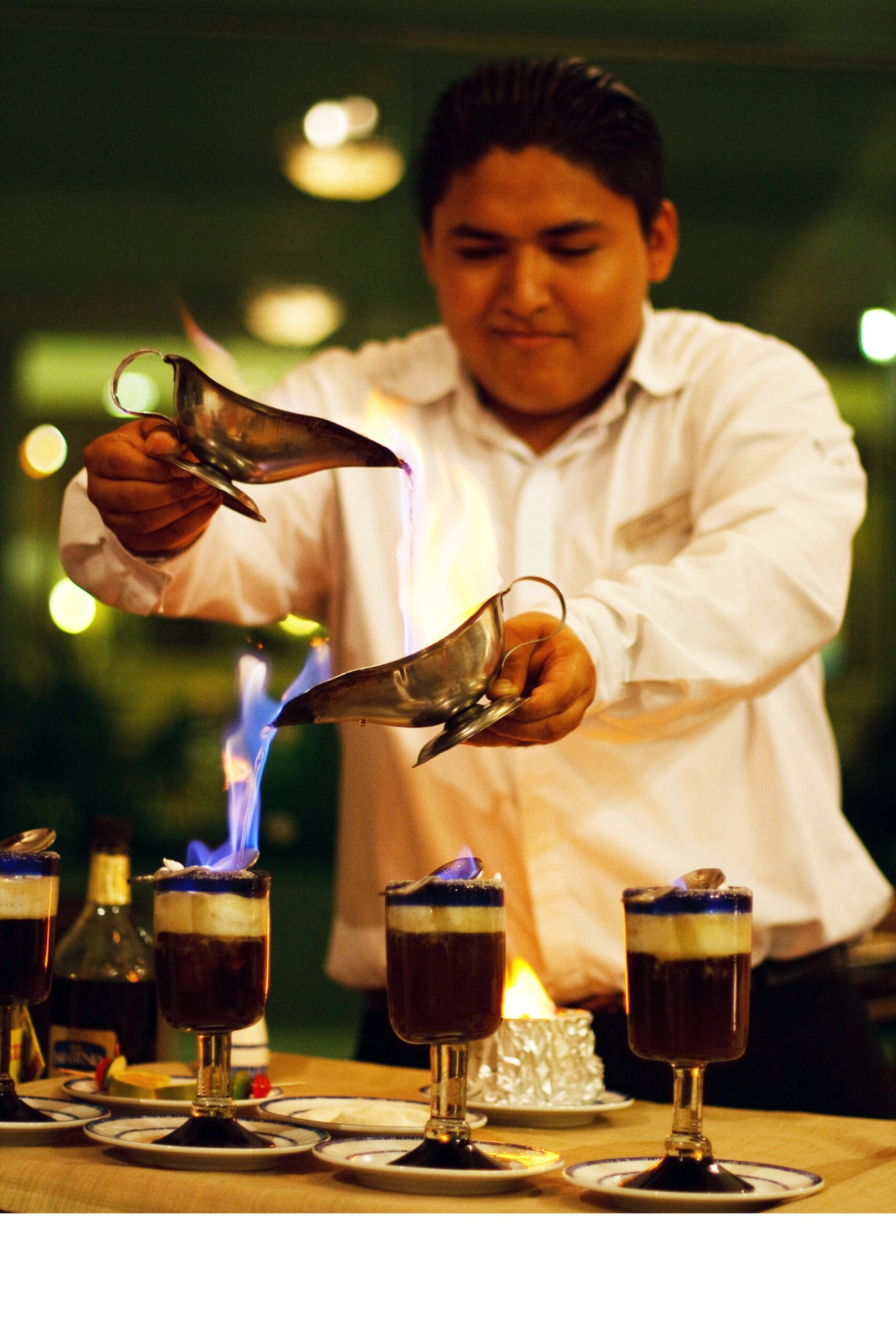 Man preparing tableside flaming Mayan coffee