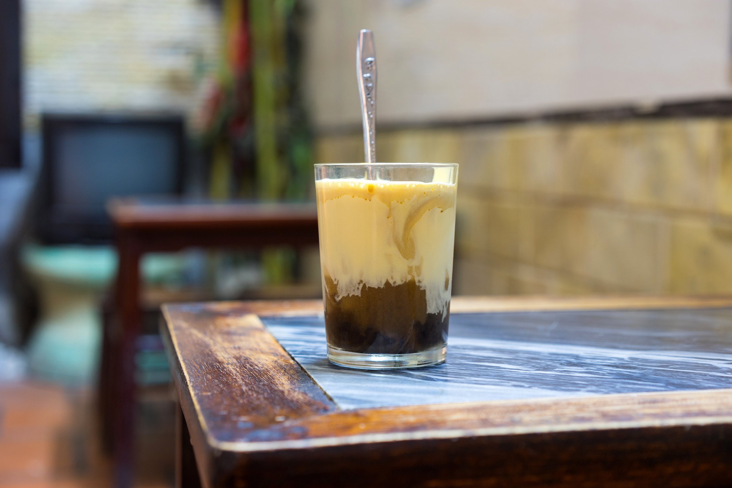 Vietnamese egg coffee on a cafe table outside