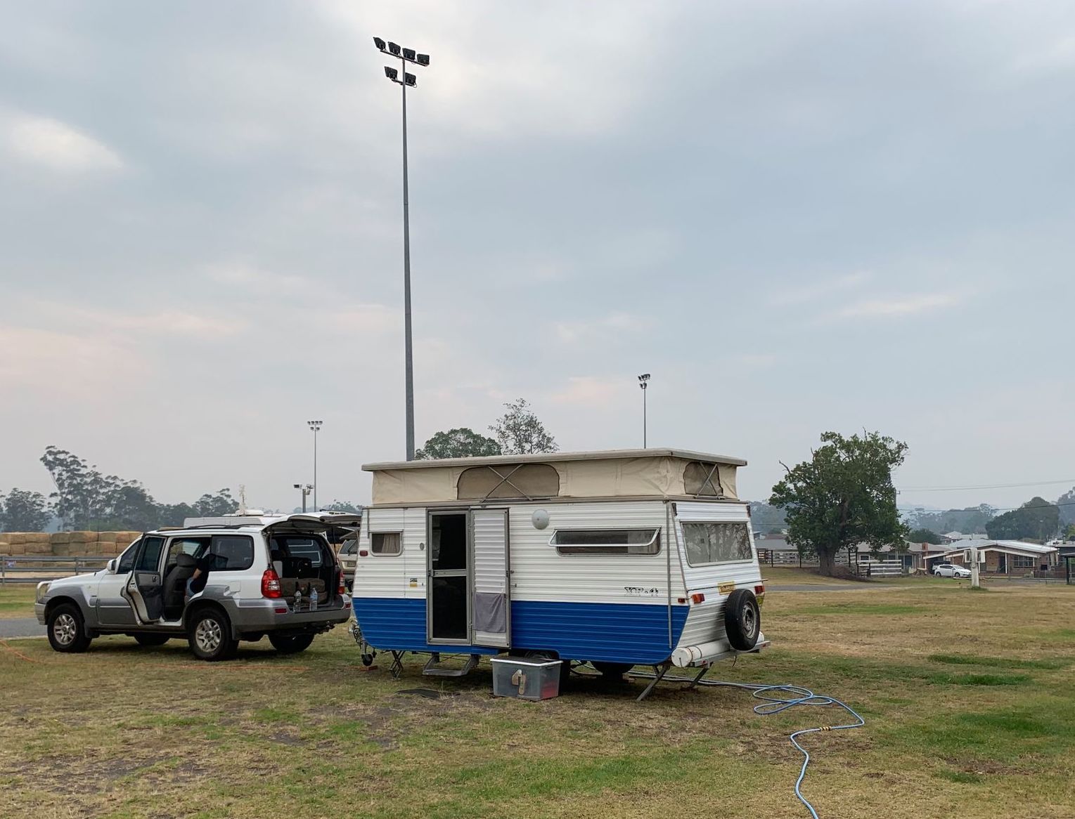 RV Trailer Hooked to SUV at Dump Station