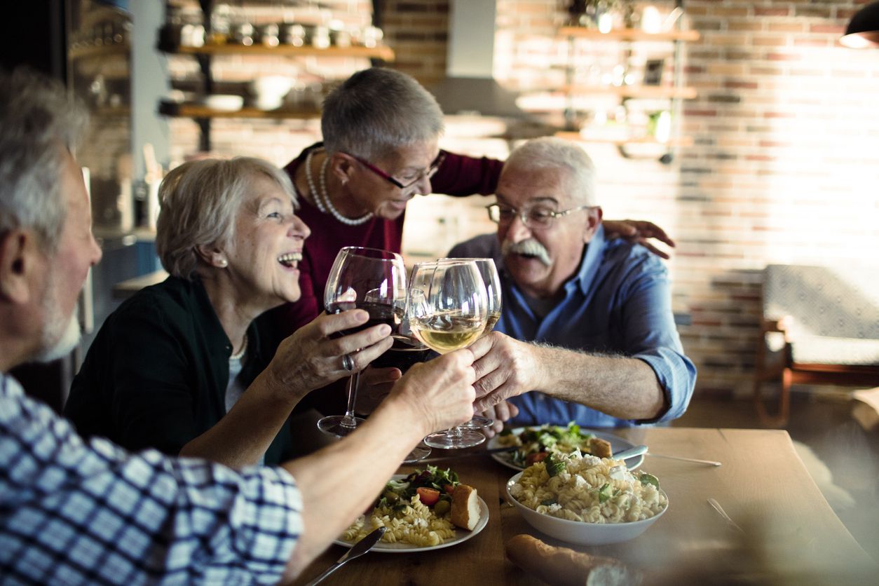 elderly people drinking wine