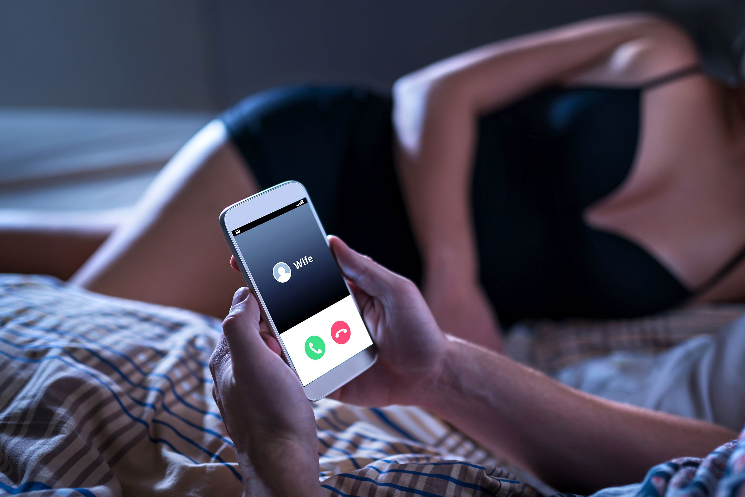 cheating unfaithful man lying with mistress in hotel bed