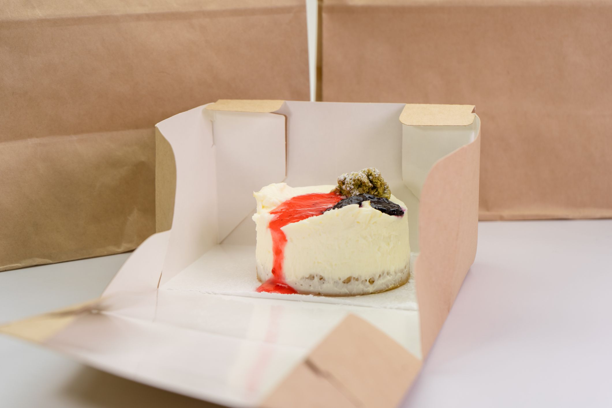 Delicious cheesecake in eco packaging, food and dessert delivery concept.