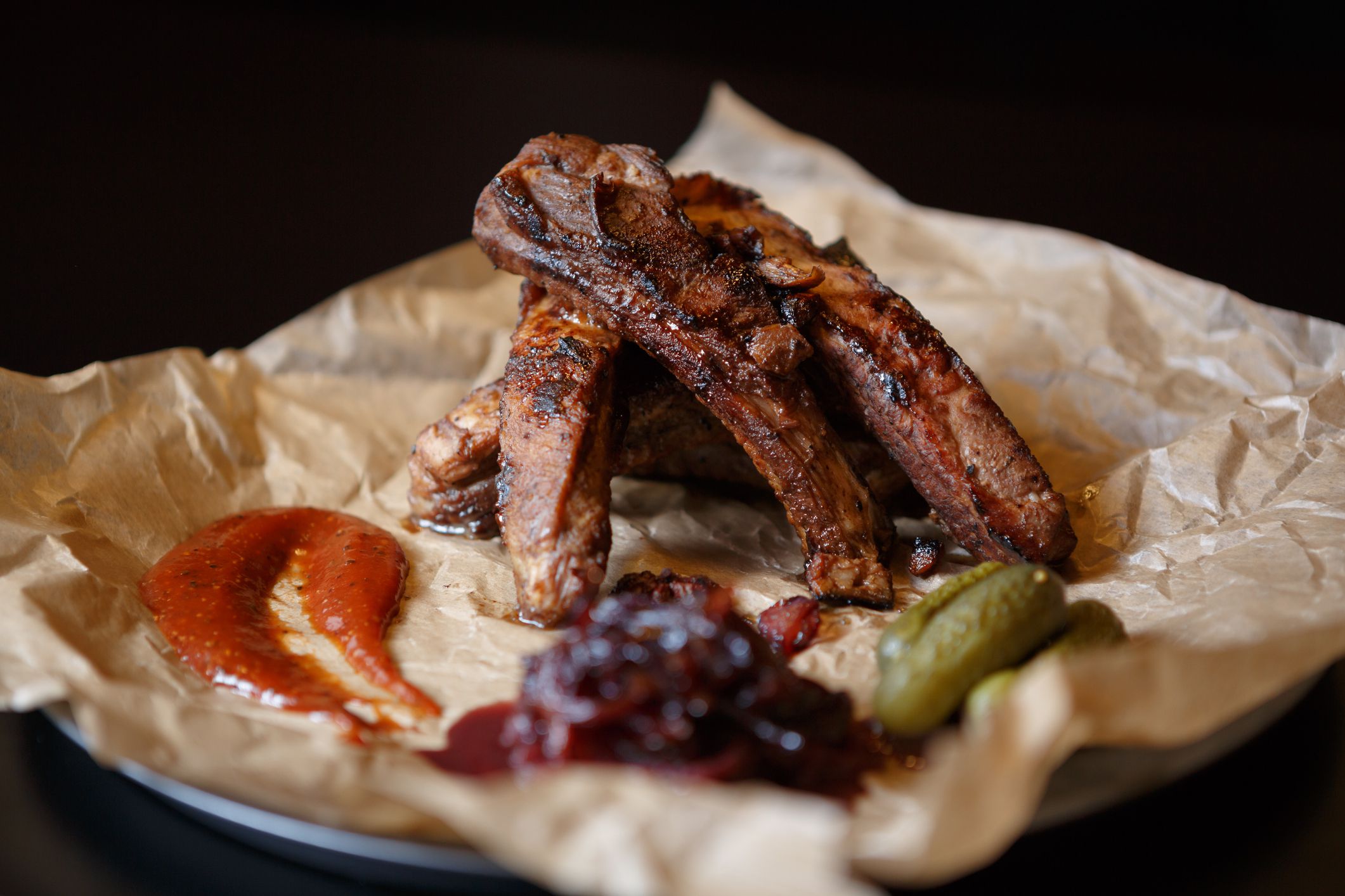 Roasted meat on bone in cafe menu.Burned pork ribs served on paper plate in fast food restaurant menu.Delicious,but unhealthy fast food
