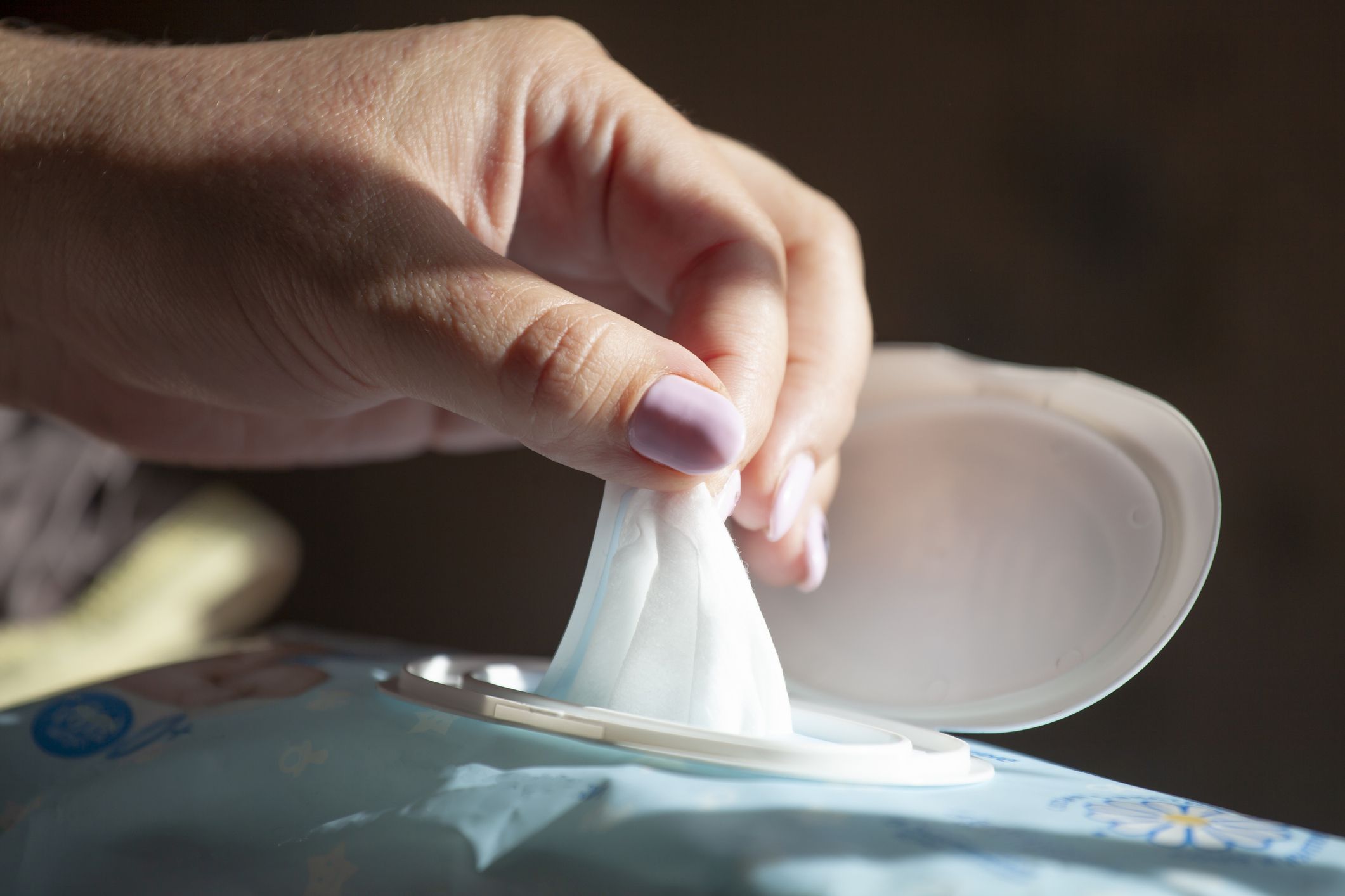 close-up of hand pulling out baby wipes
