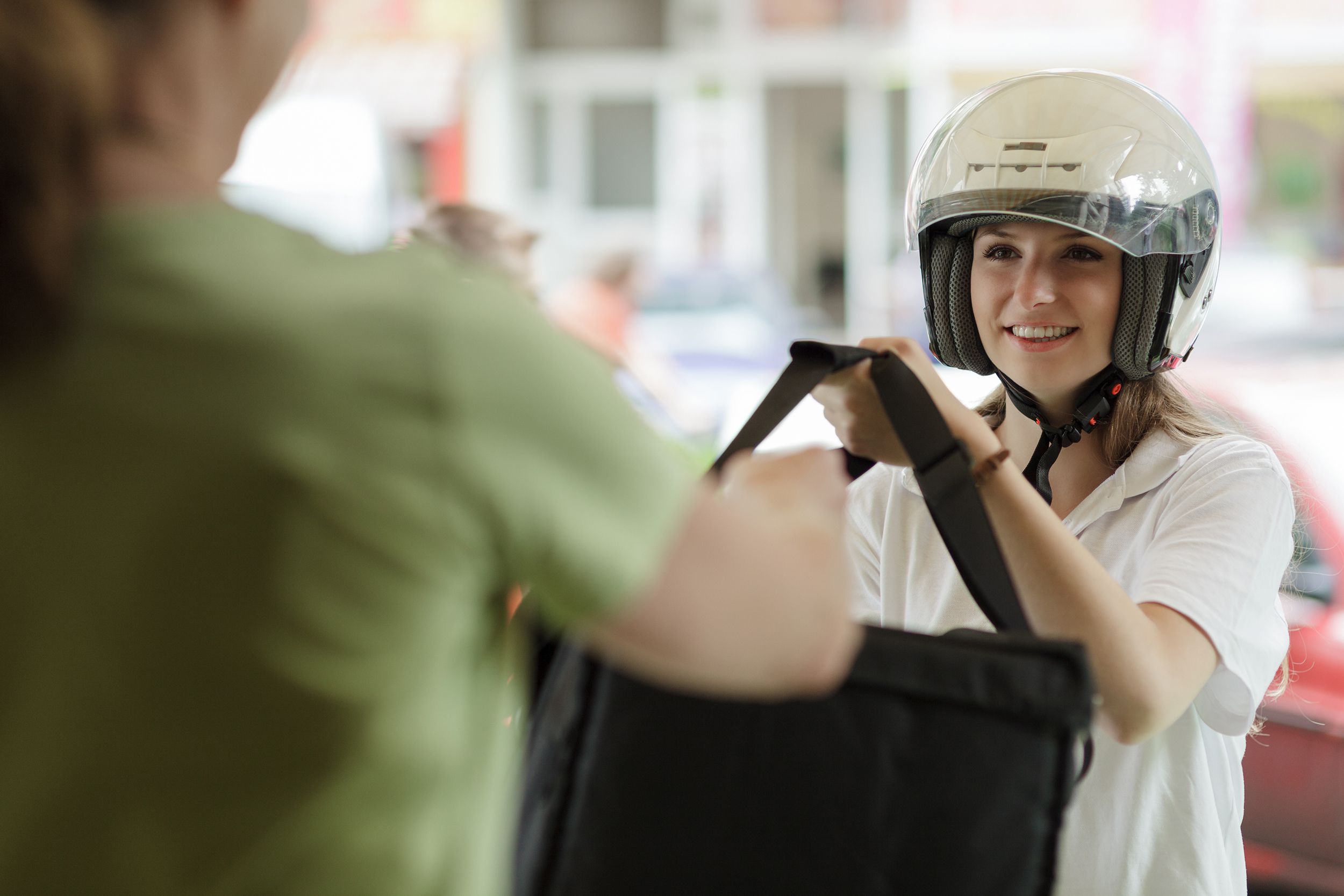 woman delivery person giving food package to customer at door