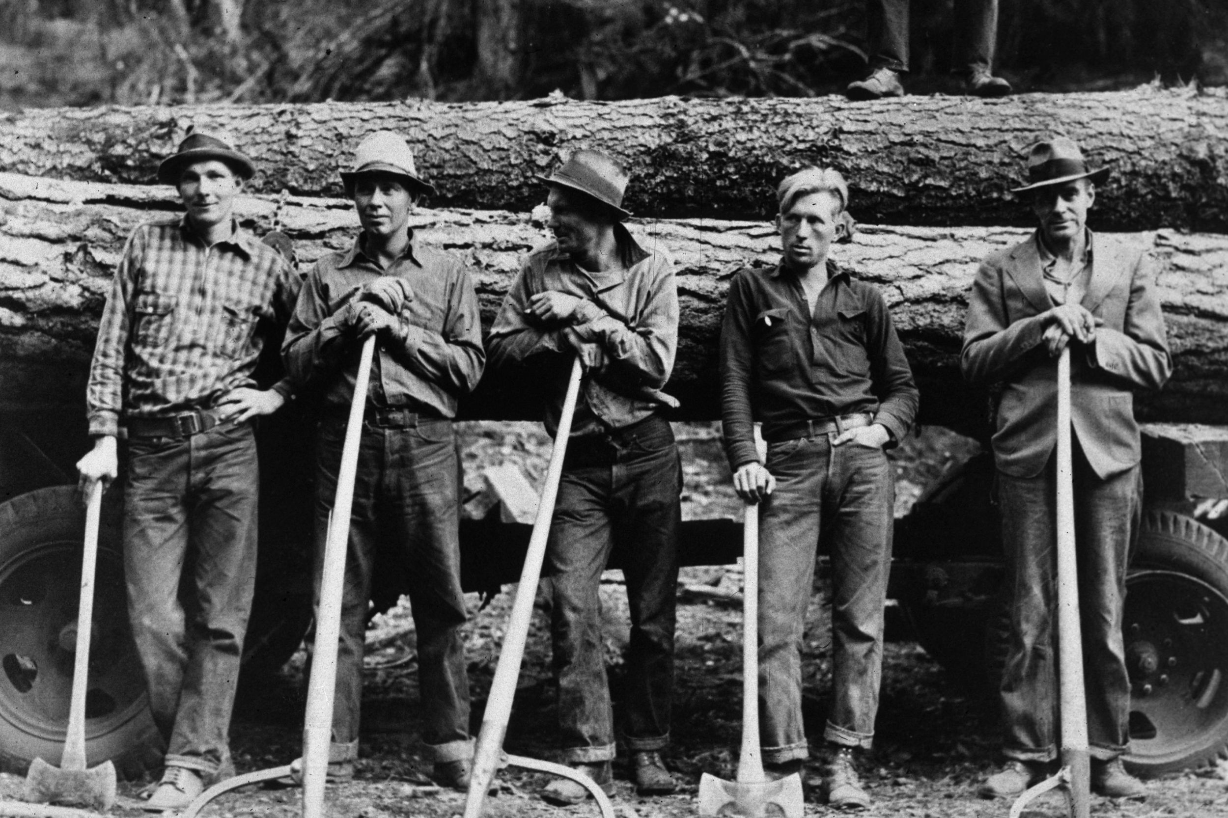 October 1939: Five farmers standing in front of a load of logs in Ola, Idaho.