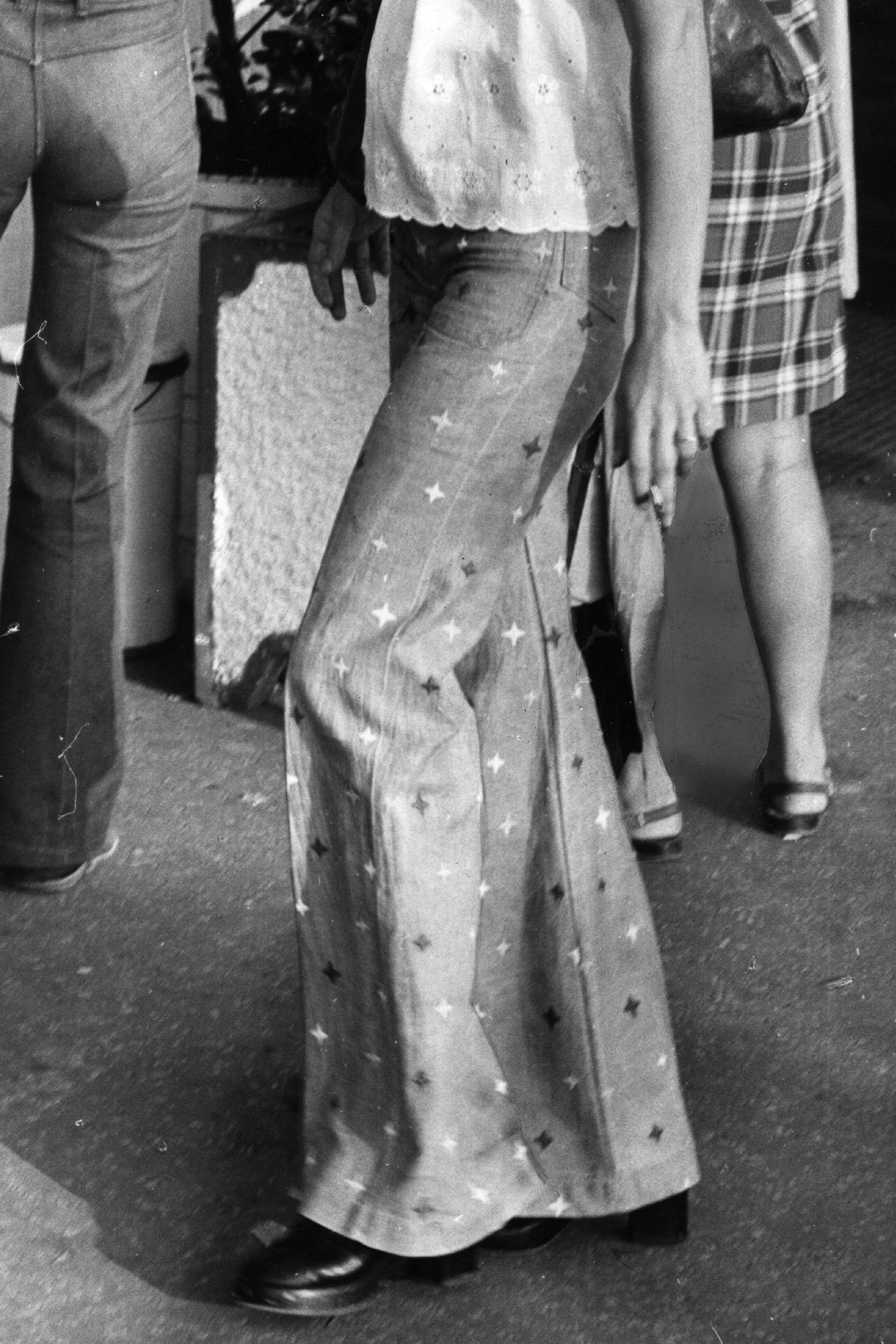 A visitor to St Tropez wearing star patterned flared jeans.