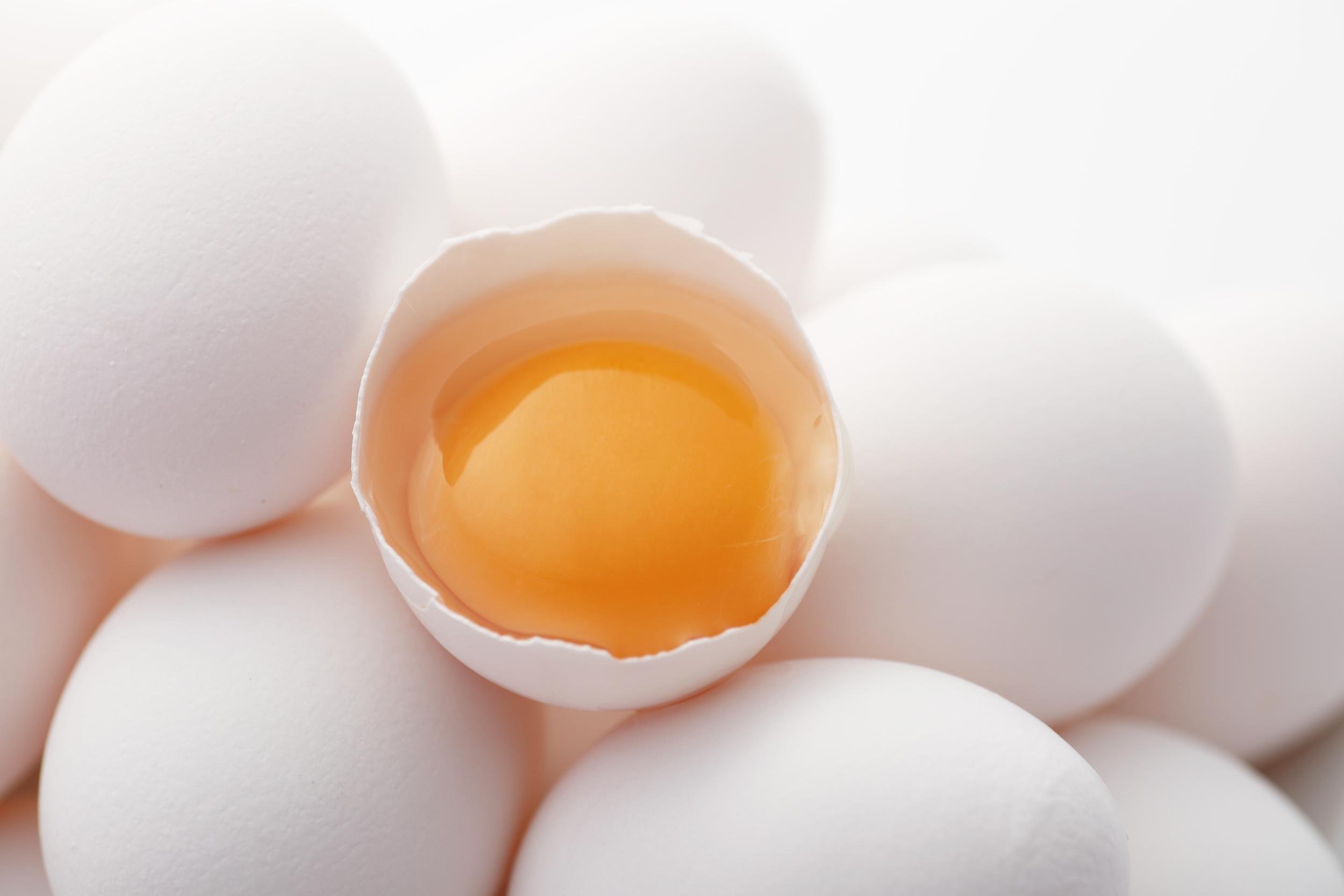 eggs with one eggs cracked and yolk showing