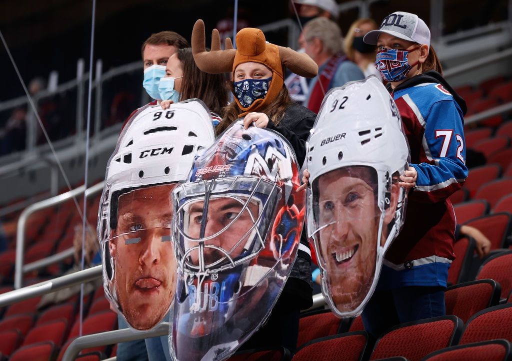 Fans of the Colorado Avalanche hold up cutouts of Mikko Rantanen #96, Philipp Grubauer #31 and Gabriel Landeskog #92 during warm-ups