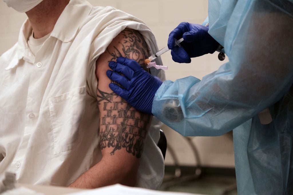 A prisoner at the Bolivar County Correctional Facility receives a Covid-19 vaccination administered by medical workers