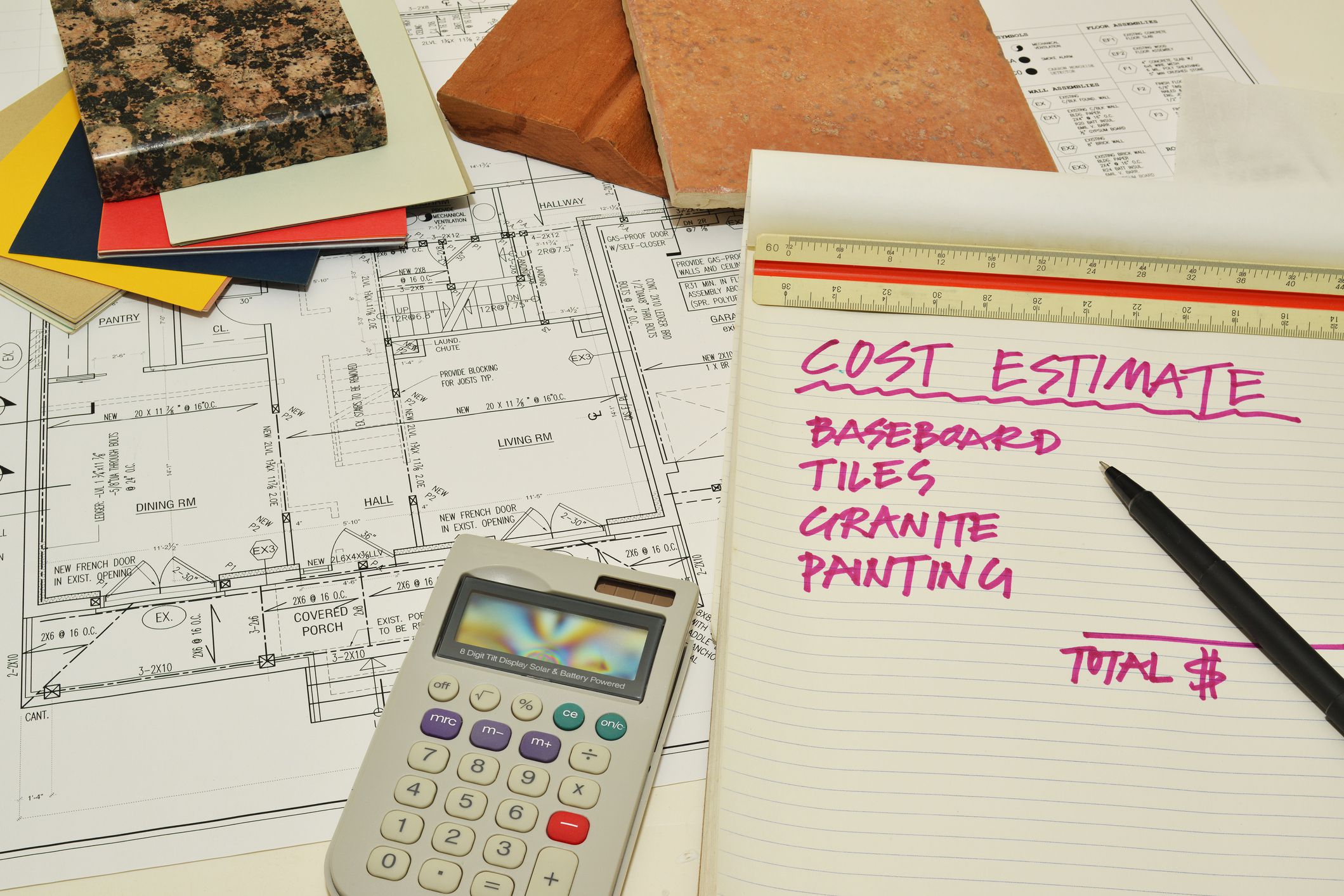 house renovation blueprint with samples of finishing materials and a weighting pad