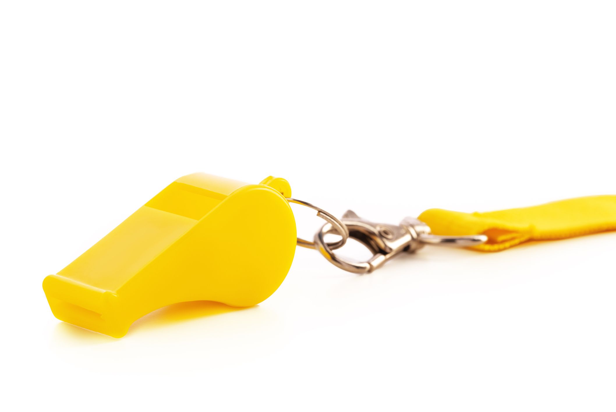 Yellow sport whistle isolated on white background