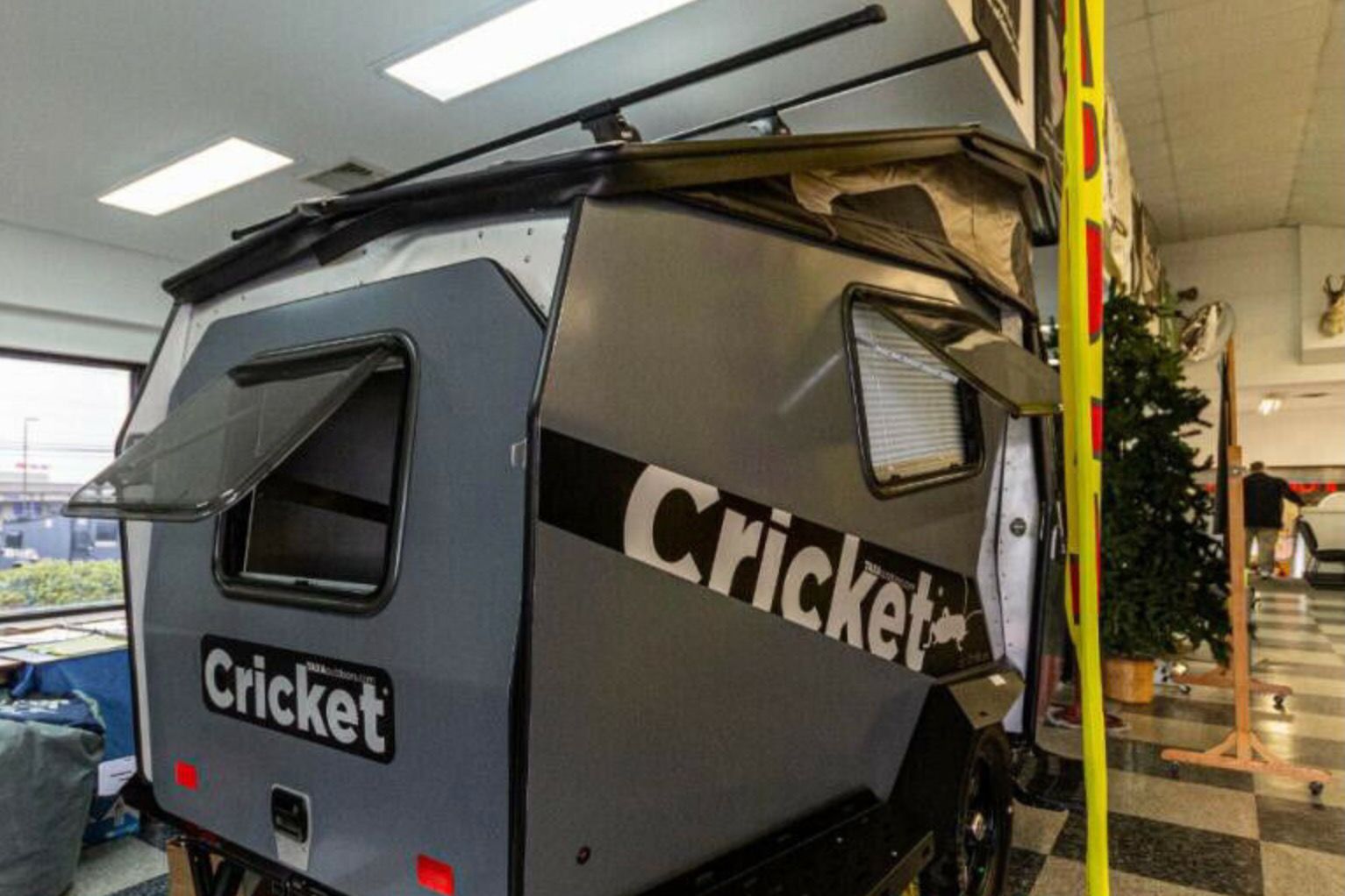 Gray trailer parked indoor.
