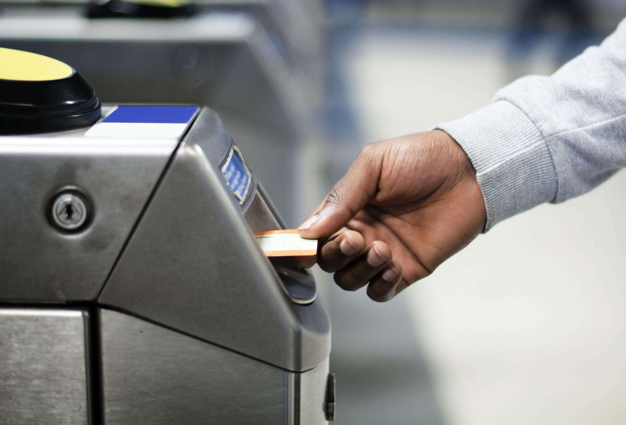Man inserting a subway pass
