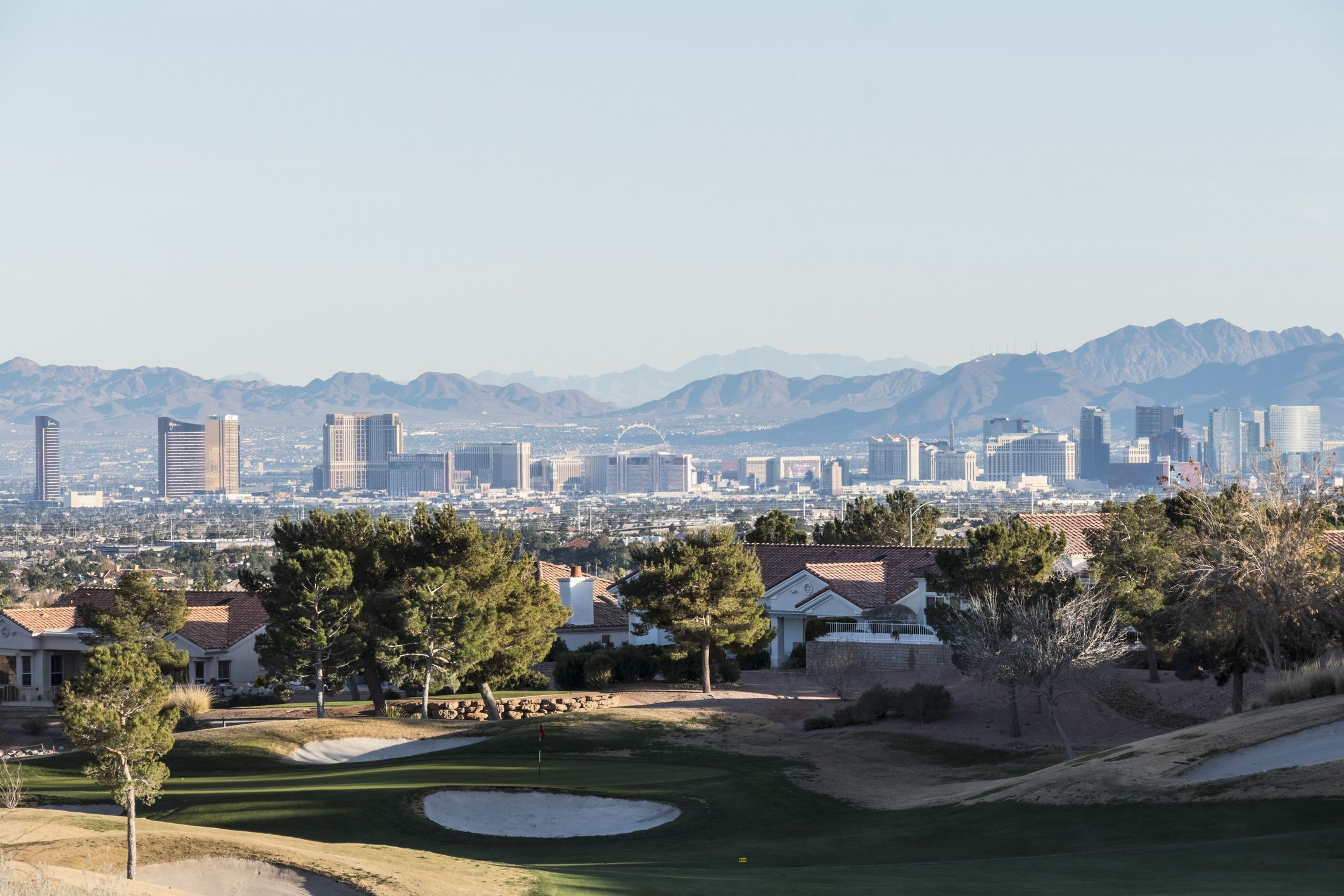 Las Vegas, Nevada, USA - December 27, 2014: Clear winter sky above golf course homes and casino resort towers in Southern Nevada.