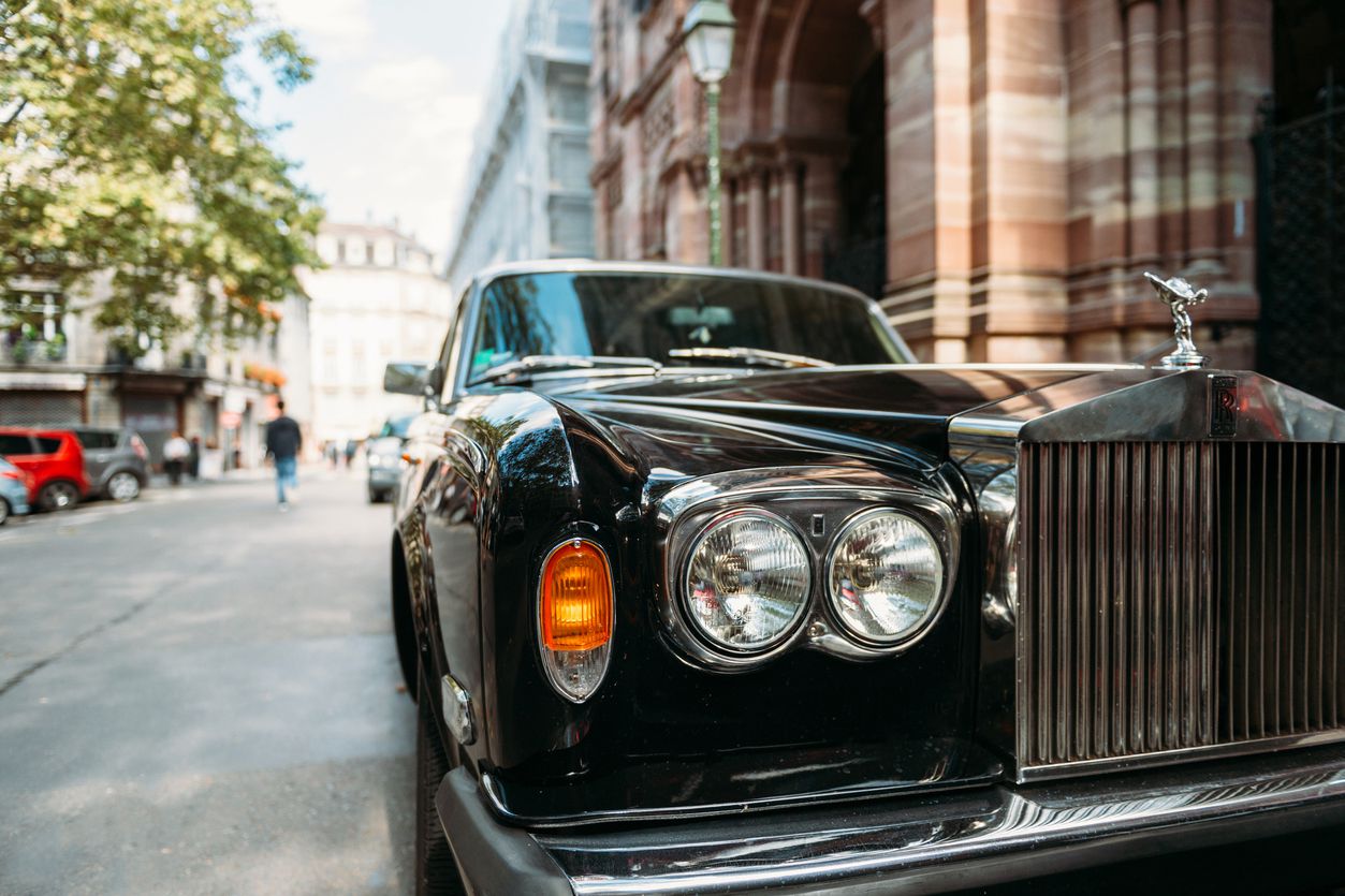 rolls-royce parked on scenic street in paris