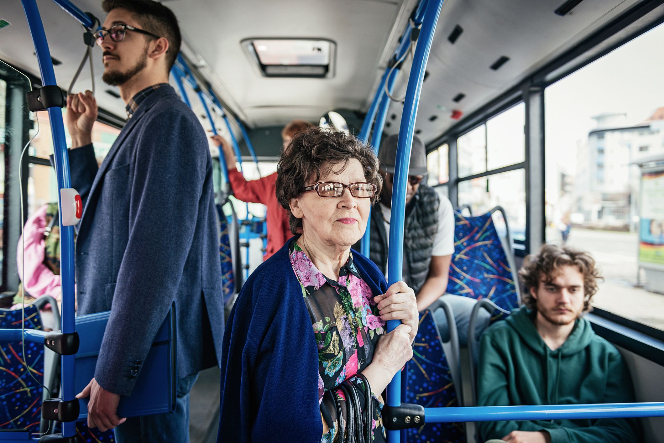 People using public transportation every day. Multi ethnic group of people of all ages use public bus for commuting.
