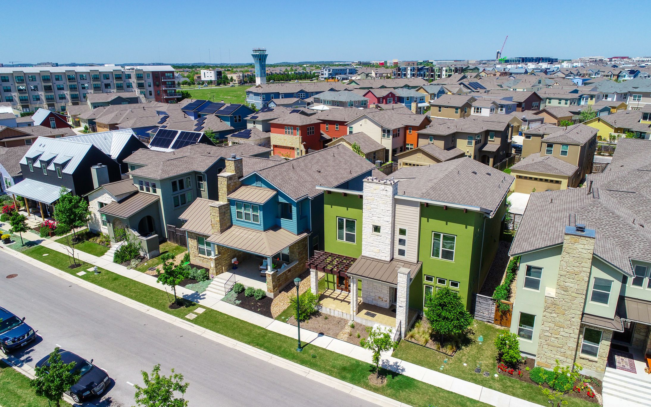 Green and blue and colorful houses facade Aerial drone view of suburb neighborhood in East Austin community houses and homes - Mueller Suburb Solar Panel Rooftops and Modern Austin Living