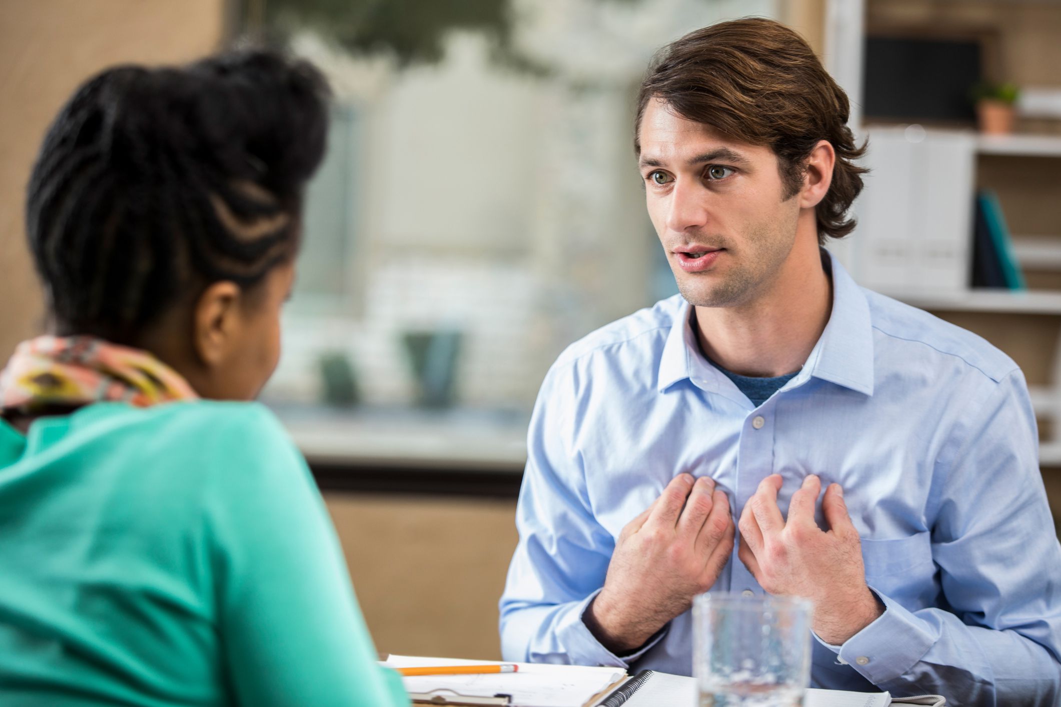 man speaking to therapist gesturing towards himself