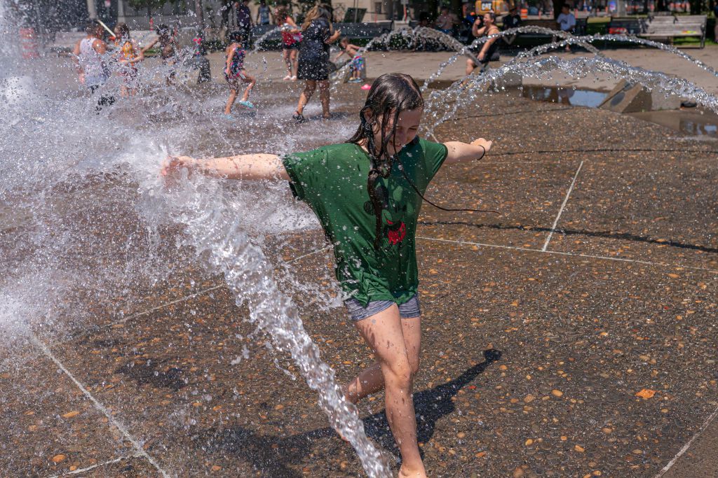 Kids play in the Salmon Springs Fountain on June 27, 2021 in Portland, Oregon. Record breaking temperatures lingered over the Northwest during a historic heatwave this weekend.