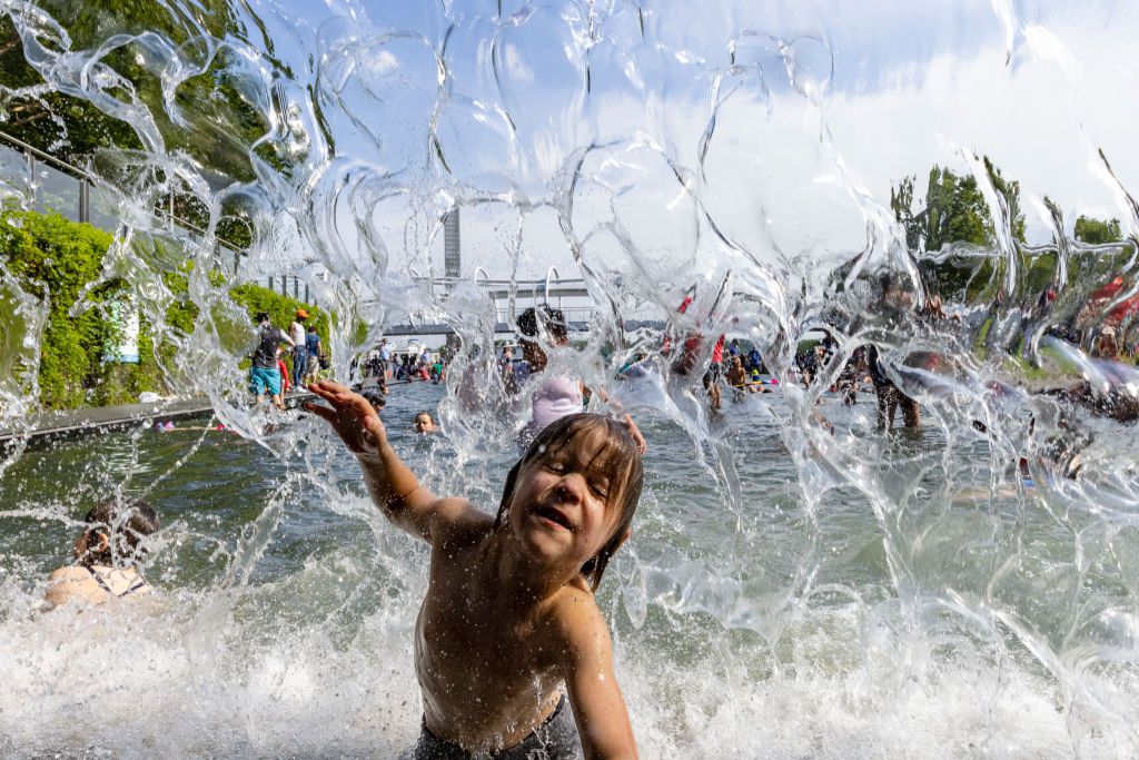 Merrick, 4 of Virginia Beach, cools off in the Yards Park splash pad on June 20, 2021 in Washington, DC. Many people took the chance to cool off with the sunny, warm weather reaching into the upper nineties today.