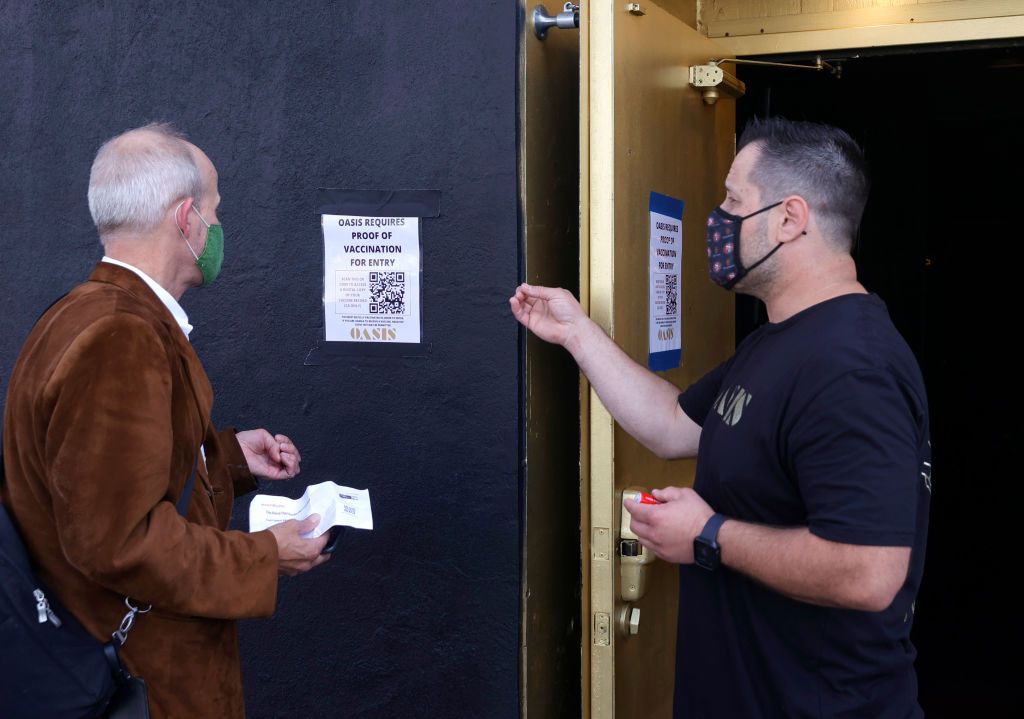 doorman at Oasis informs a customer that a vaccination card is required to enter the club on July 29, 2021 in San Francisco, California.
