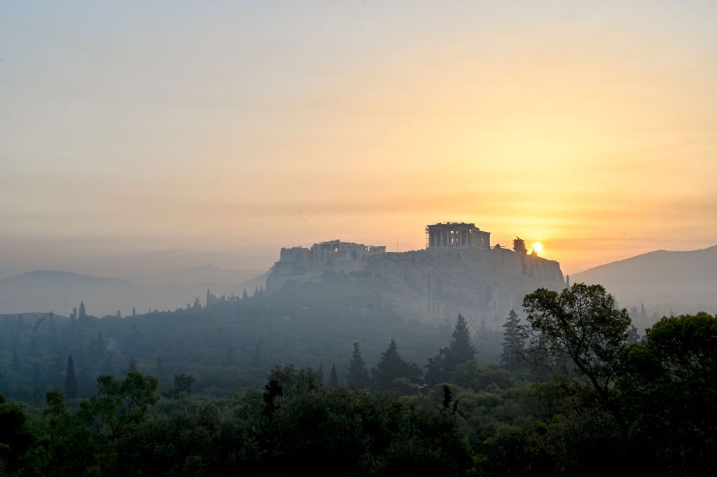 Parthenon temple on Acropolis hill is seen through smoke from a wildfire north of the Greek capital,on August 4, 2021 in Athens, Greece.