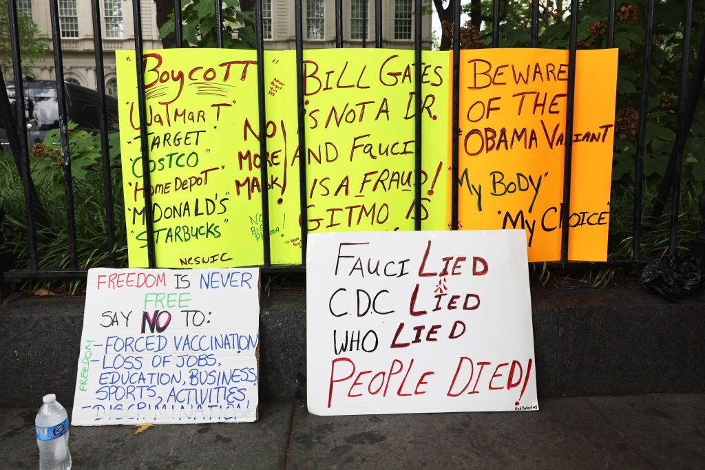 Protest signs are seen as people gather at City Hall to protest vaccine mandates on August 09, 2021 in New York City. NYC Mayor Bill de Blasio announced last week that as of August 16th proof of coronavirus (COVID-19) vaccination will be required to atten