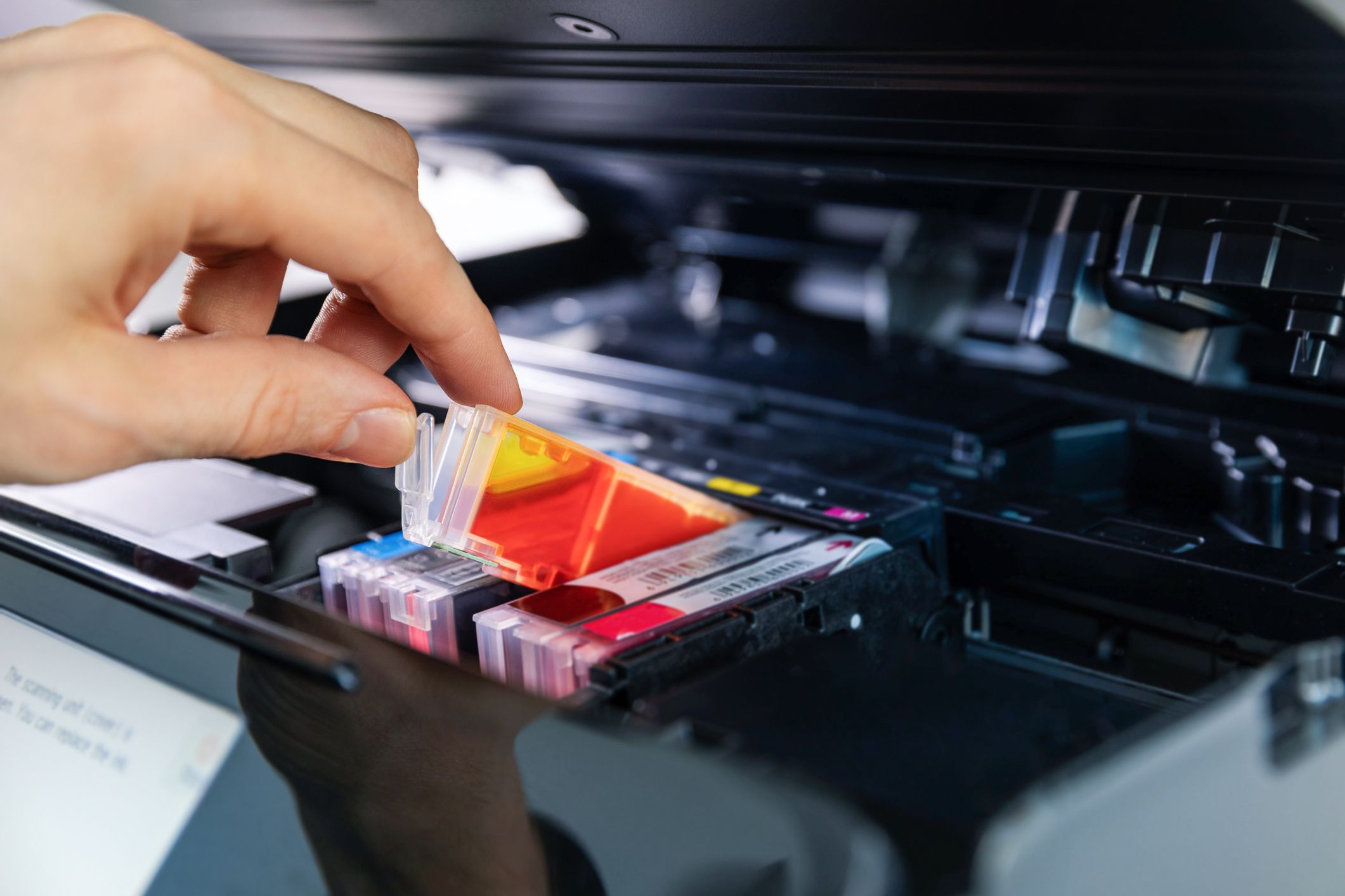 Hand replacing inkjet printer cartridge