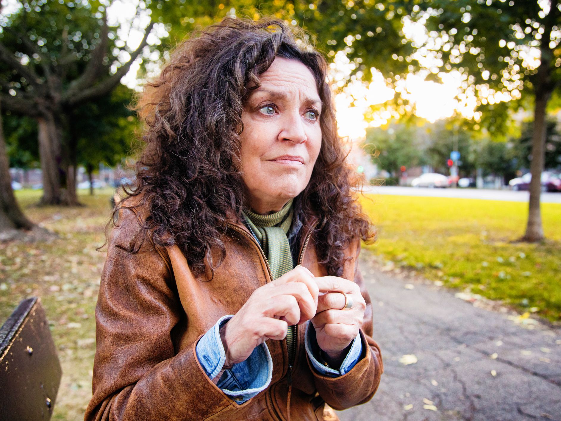 Anxious senior woman in crisis outdoors in park on an outdoors afternoon